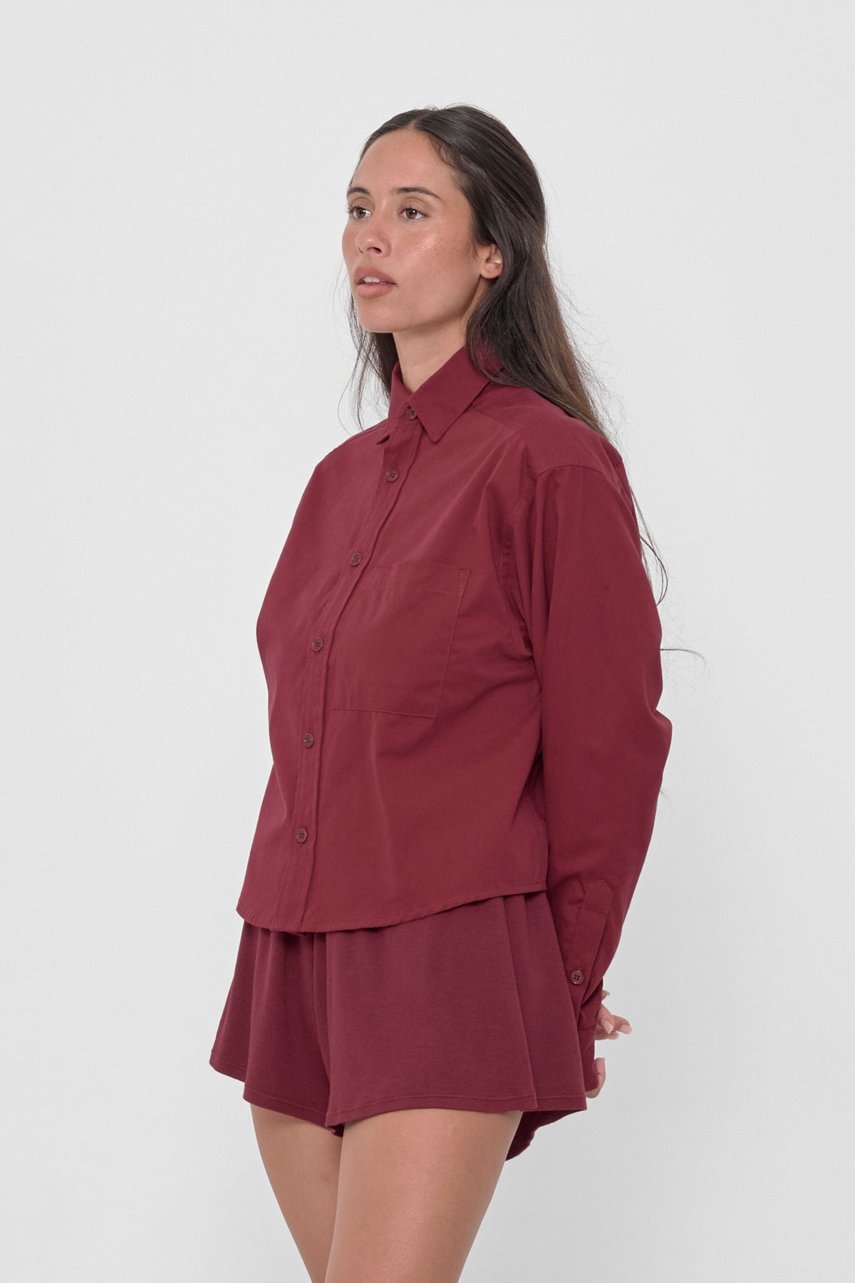 Peach Fuzz Cropped Button-Up Shirt in Garnet – 3/4 front view on model