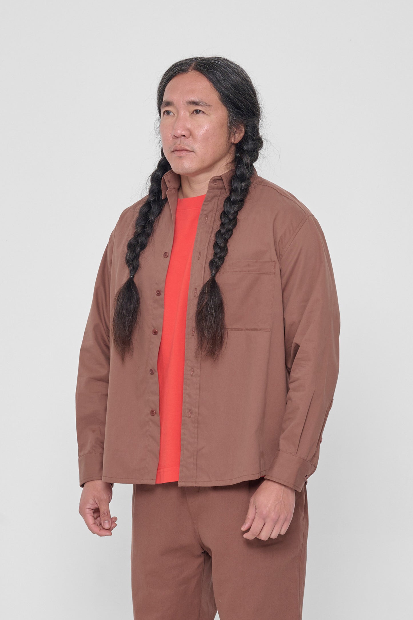 Facing 45-degrees, highlighting the shirt's sleeves. 