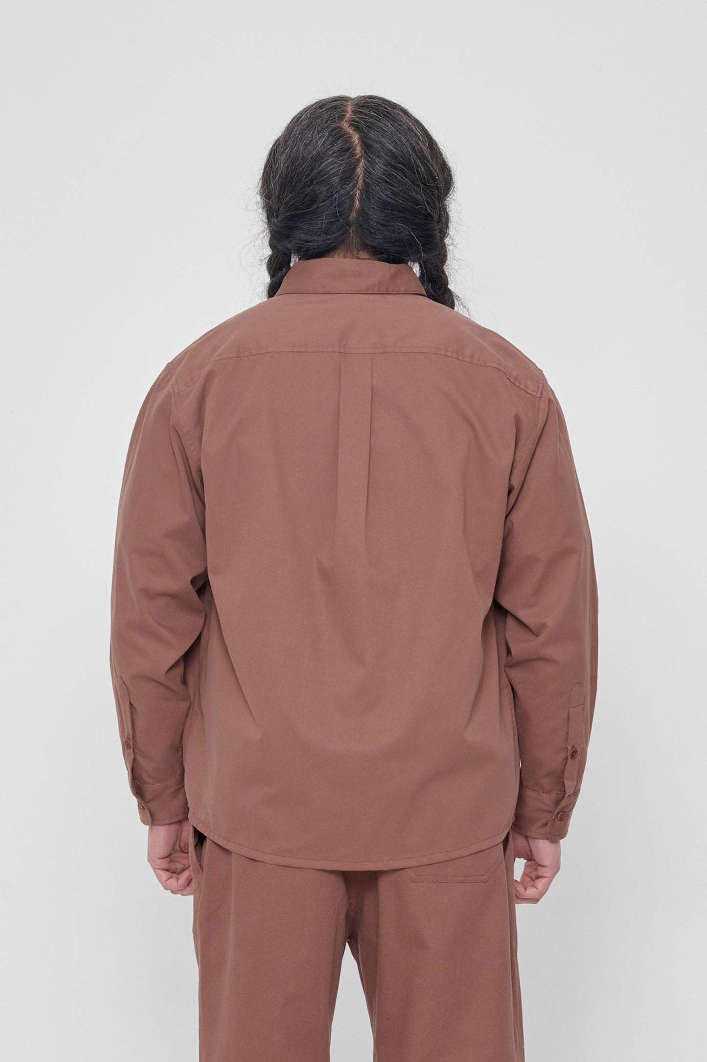 Back view: Shows the relaxed drape of the fabric and box pleat at yoke.