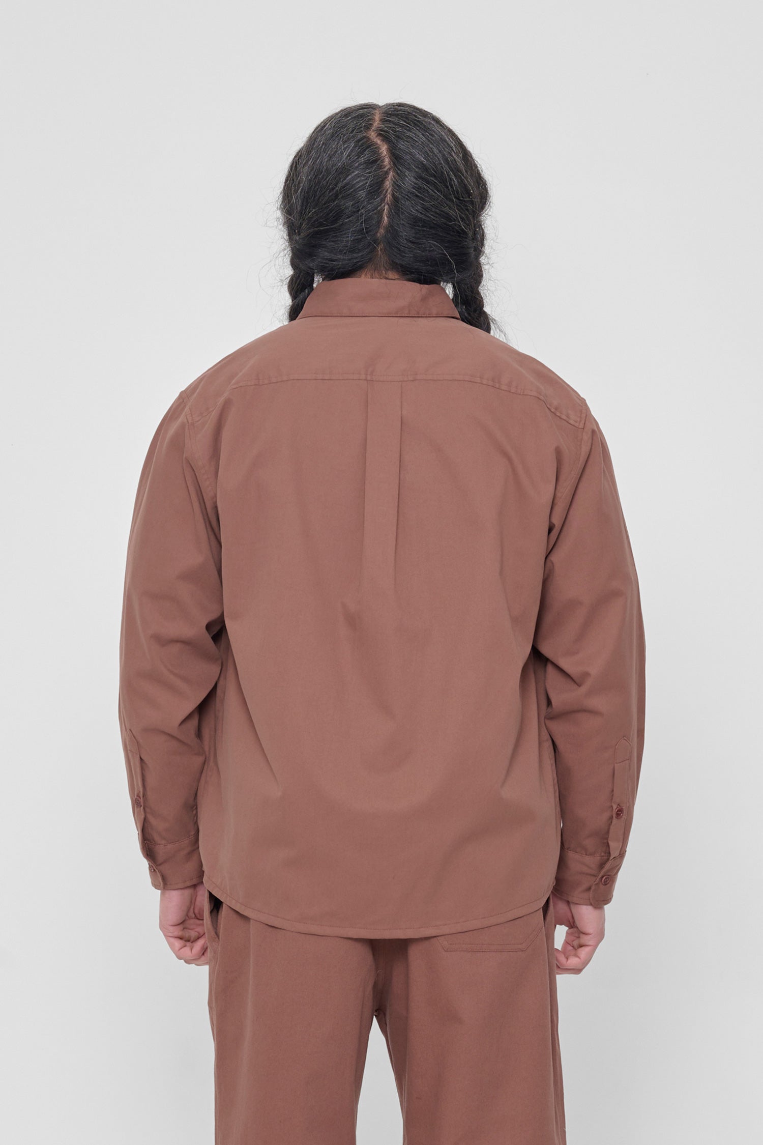 Back view: Shows the relaxed drape of the fabric and box pleat at yoke.