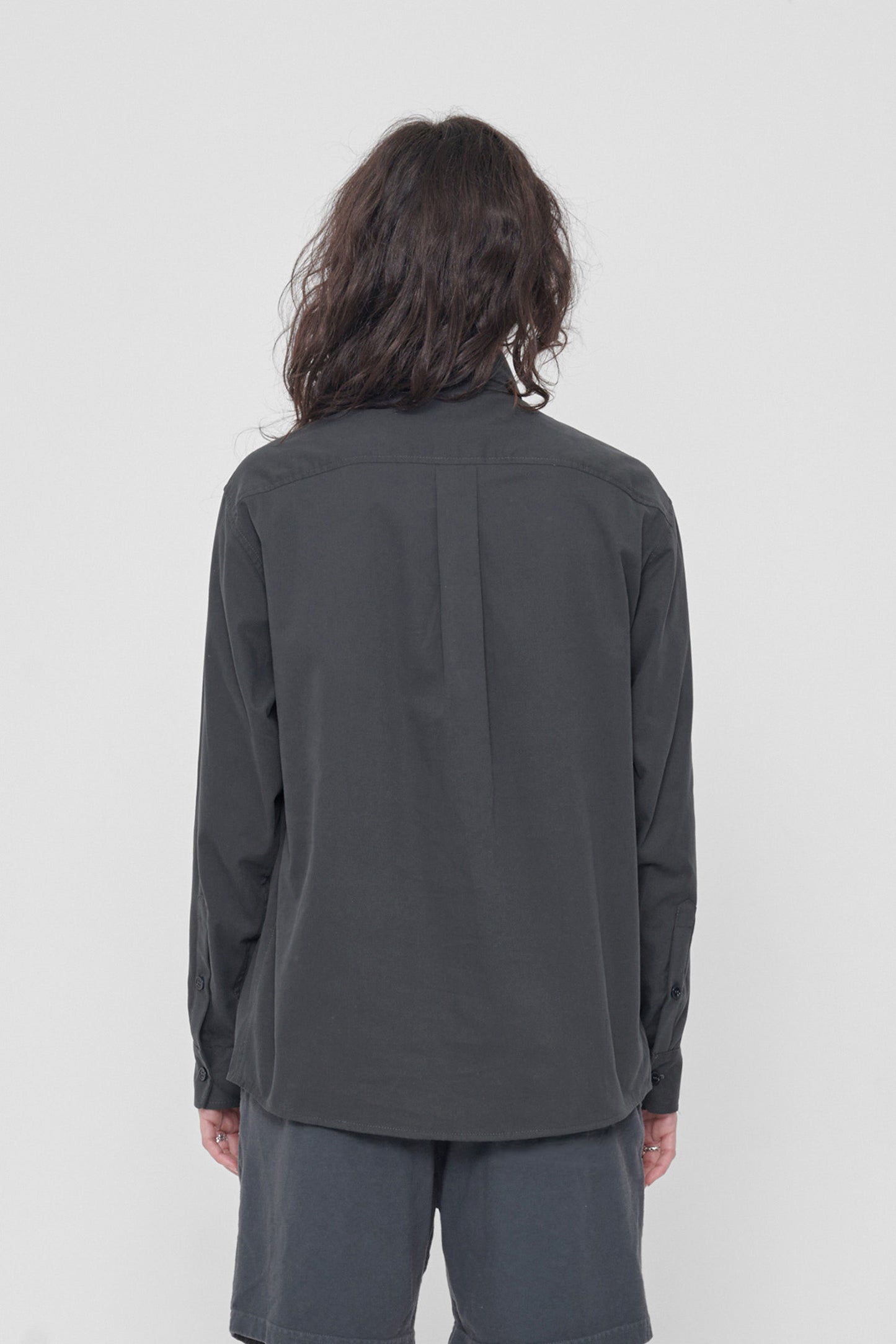 Back view: Shows the relaxed drape of the fabric and box pleat at yoke.