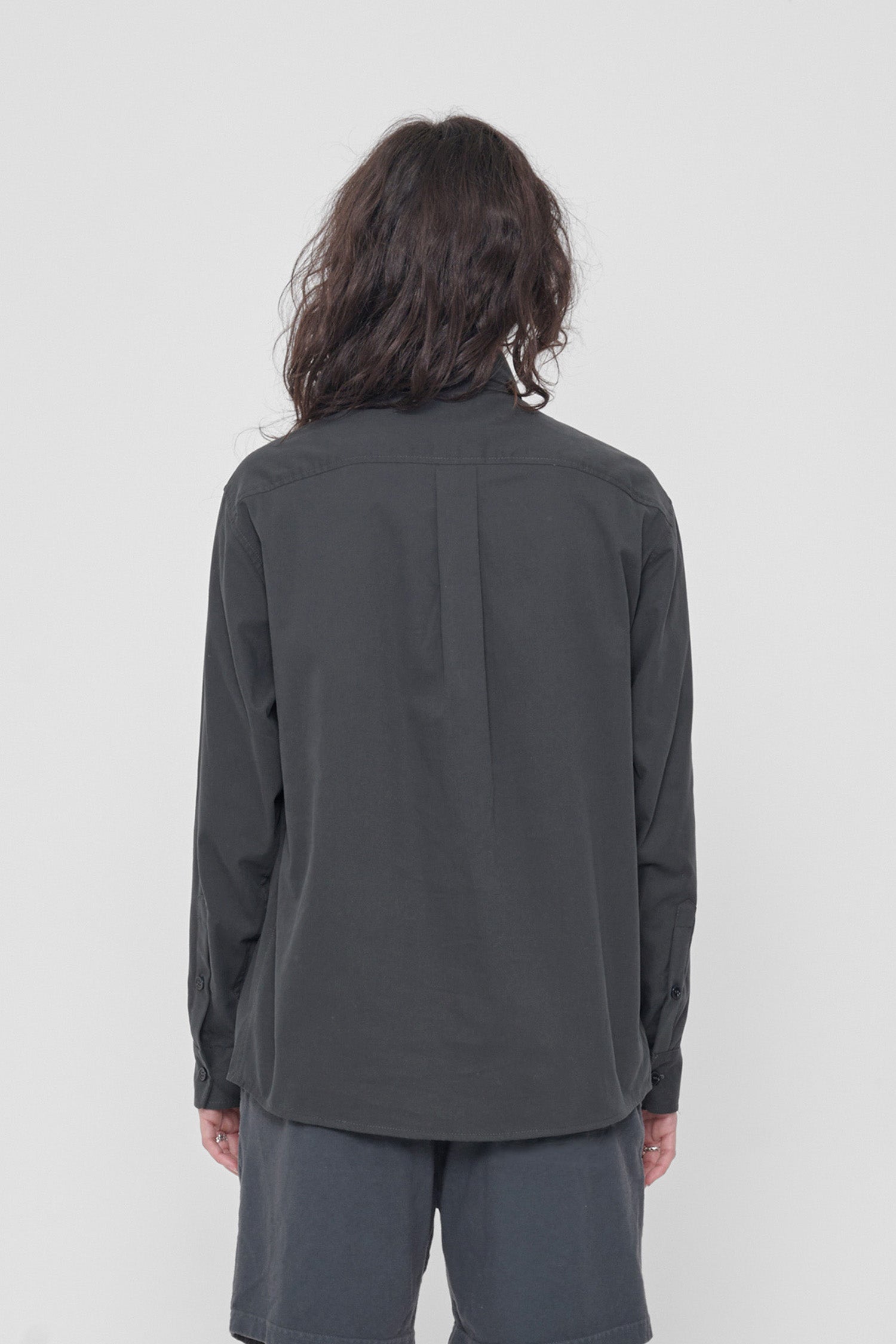 Back view: Shows the relaxed drape of the fabric and box pleat at yoke.