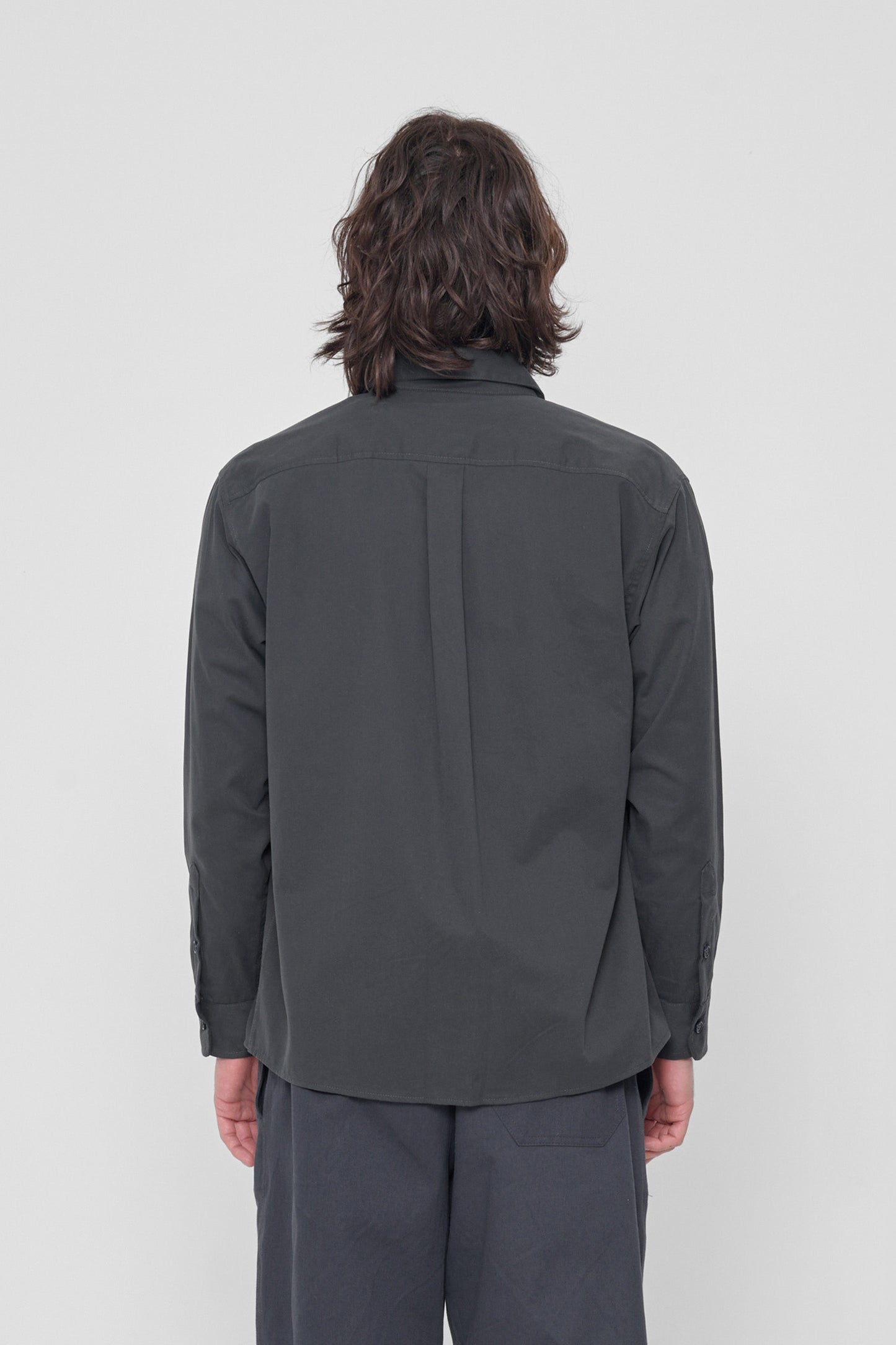 Back view: Shows the relaxed drape of the fabric and box pleat at yoke.
