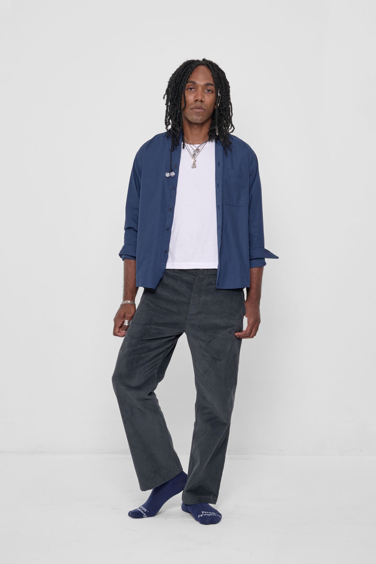 Peach Fuzz Button-Up Shirt in Washed Navy – front view on model, worn unbuttoned over a white tee, with Slate Cord Pants