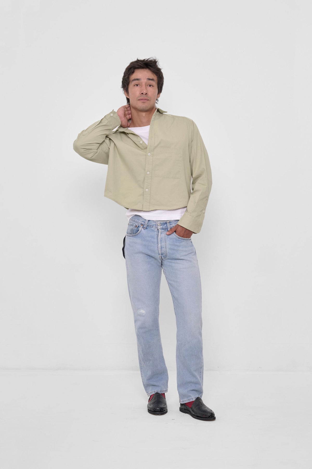 Peach Fuzz Cropped Button-Up Shirt in Oat – front view on model, layered over white tee