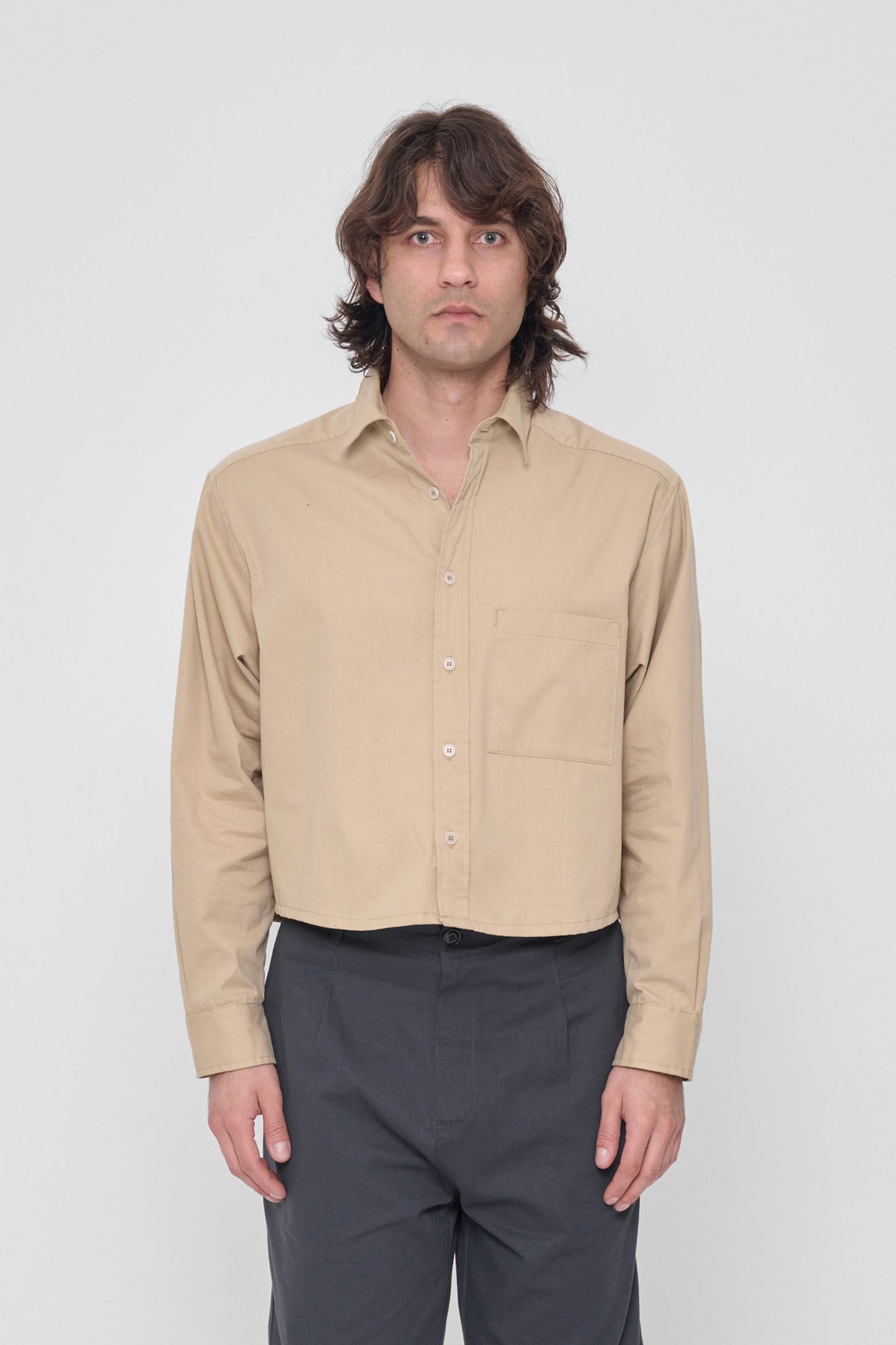 5'11" model in size XL Sand Storm Peach Fuzz Cropped Button Up Shirt. Hem hits the waist. 