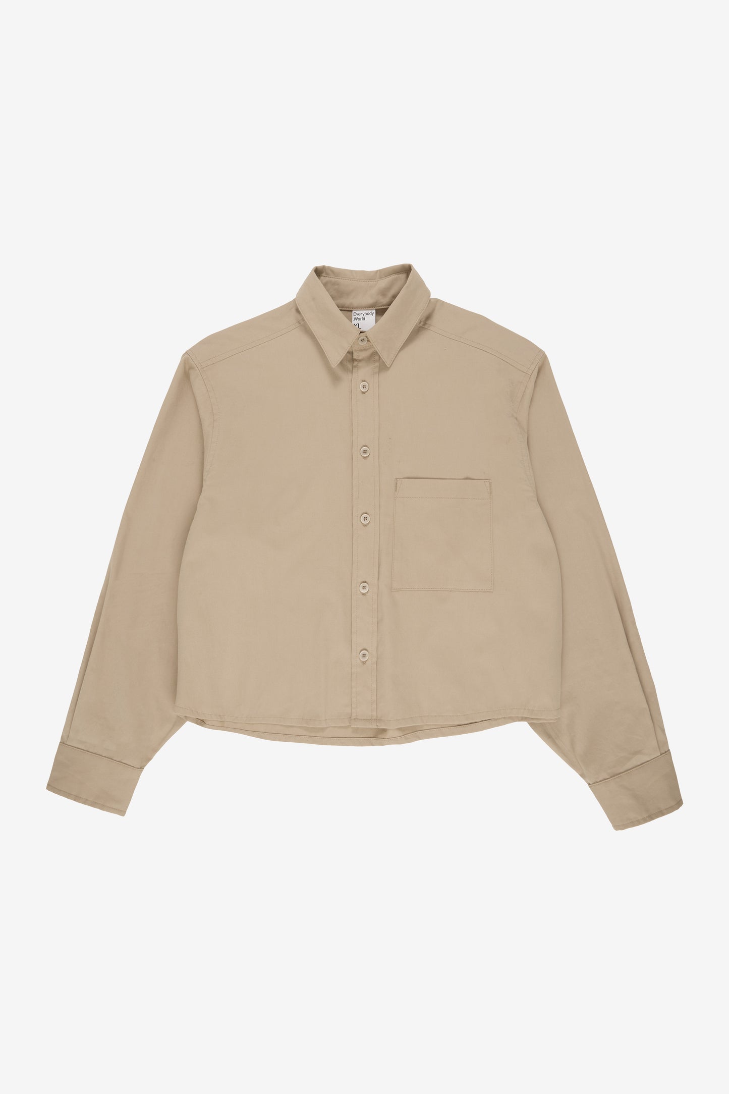 Flat lay showing boxy cropped body and straight bottom hem. 