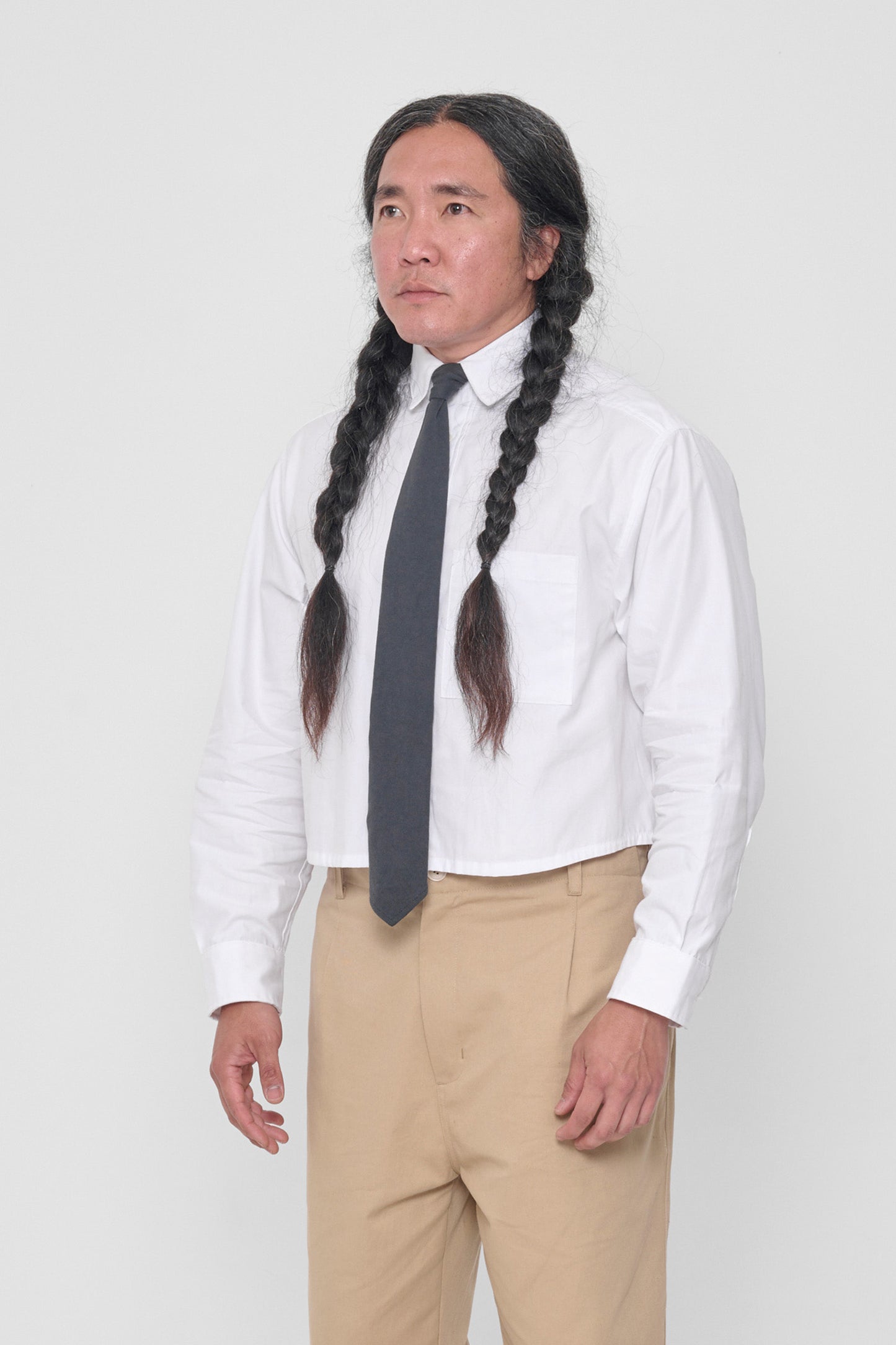 3/4 view highlighting front breast pocket and buttoned sleeve cuff. 