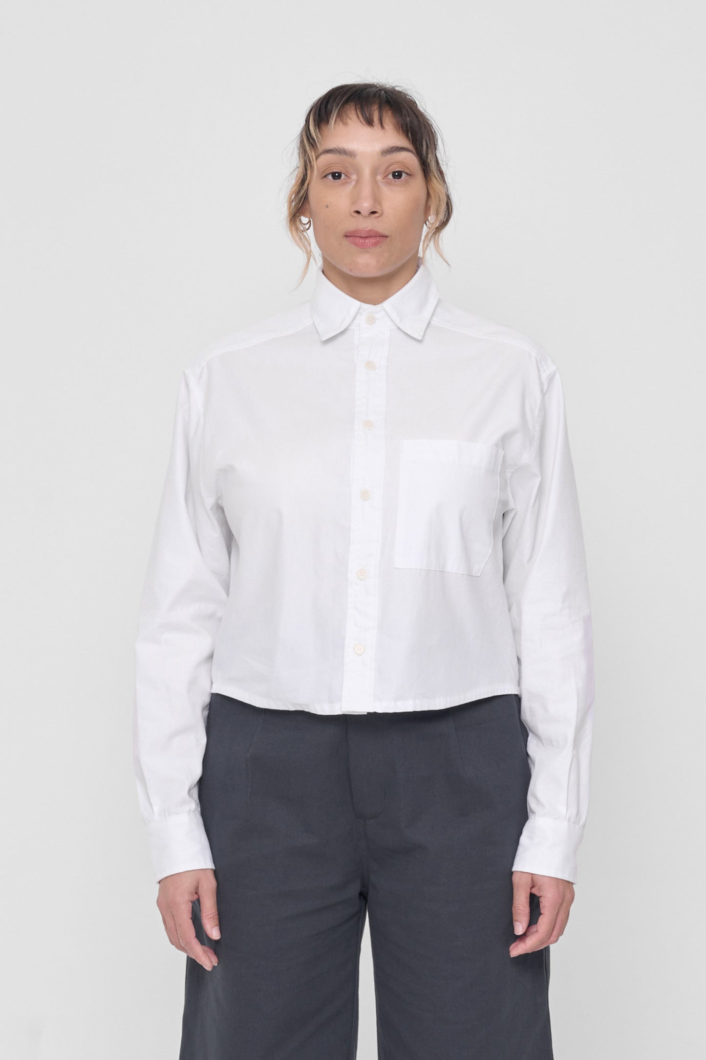 5'4" model wearing size M White Peach Fuzz Cropped Button Up Shirt. Bottom hem hits at waist. 