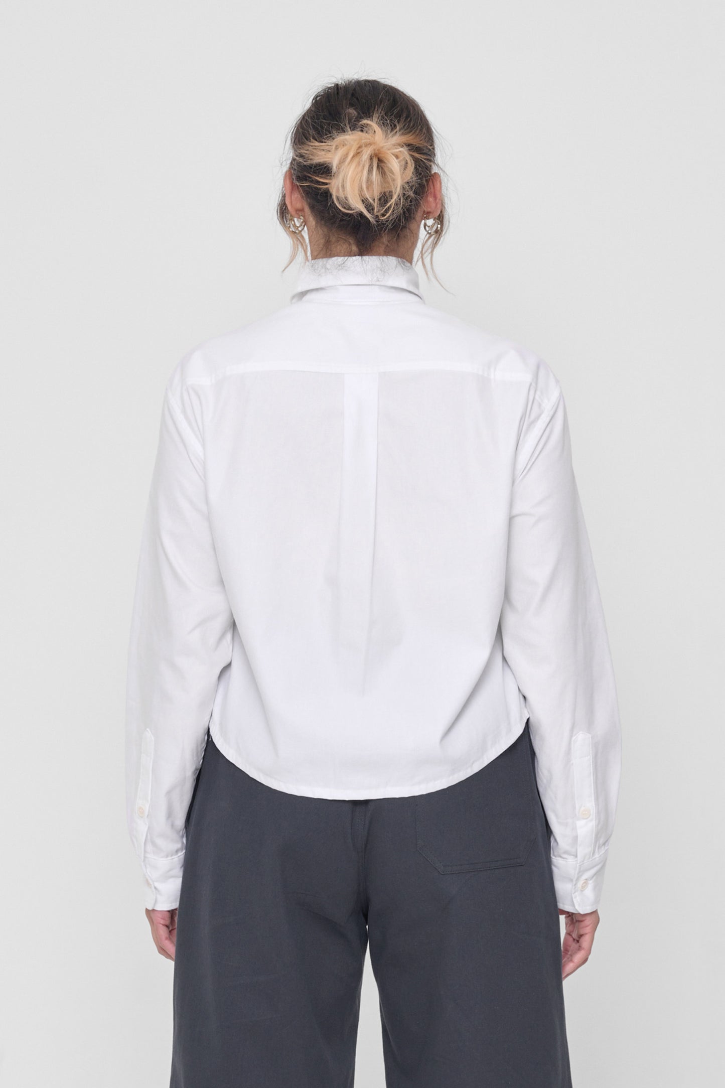 Back view highlighting box pleat at back yoke and oversized boxy fit.