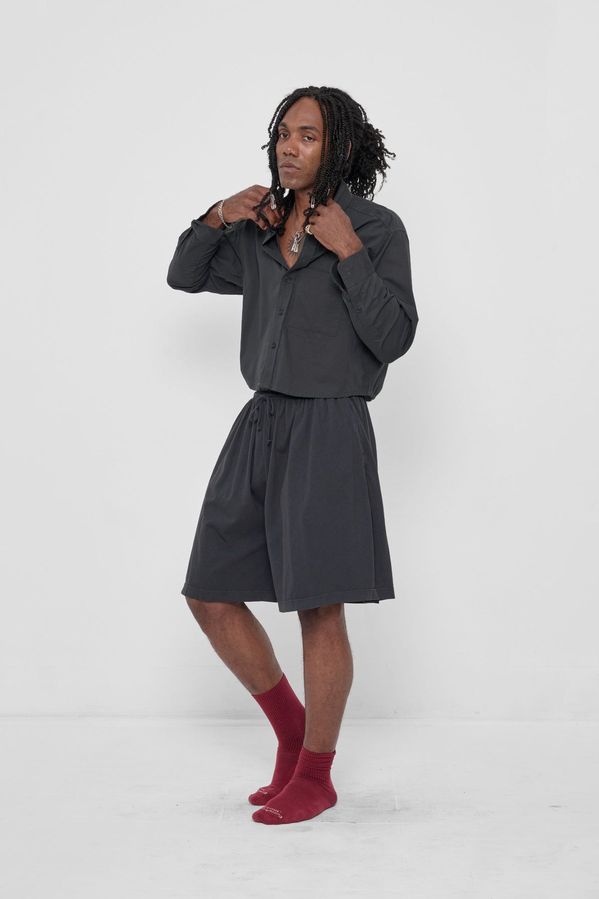 Peach Fuzz Cropped Button-Up Shirt in Slate – 3/4 front view, styled with matching Long Tubular Shorts and Garnet Spring Socks