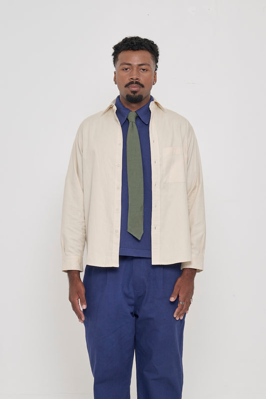 Oat Peach Fuzz Twill Button Up Shirt, worn open, with Washed Navy Trash Polo, Pine Green Trash Tie.