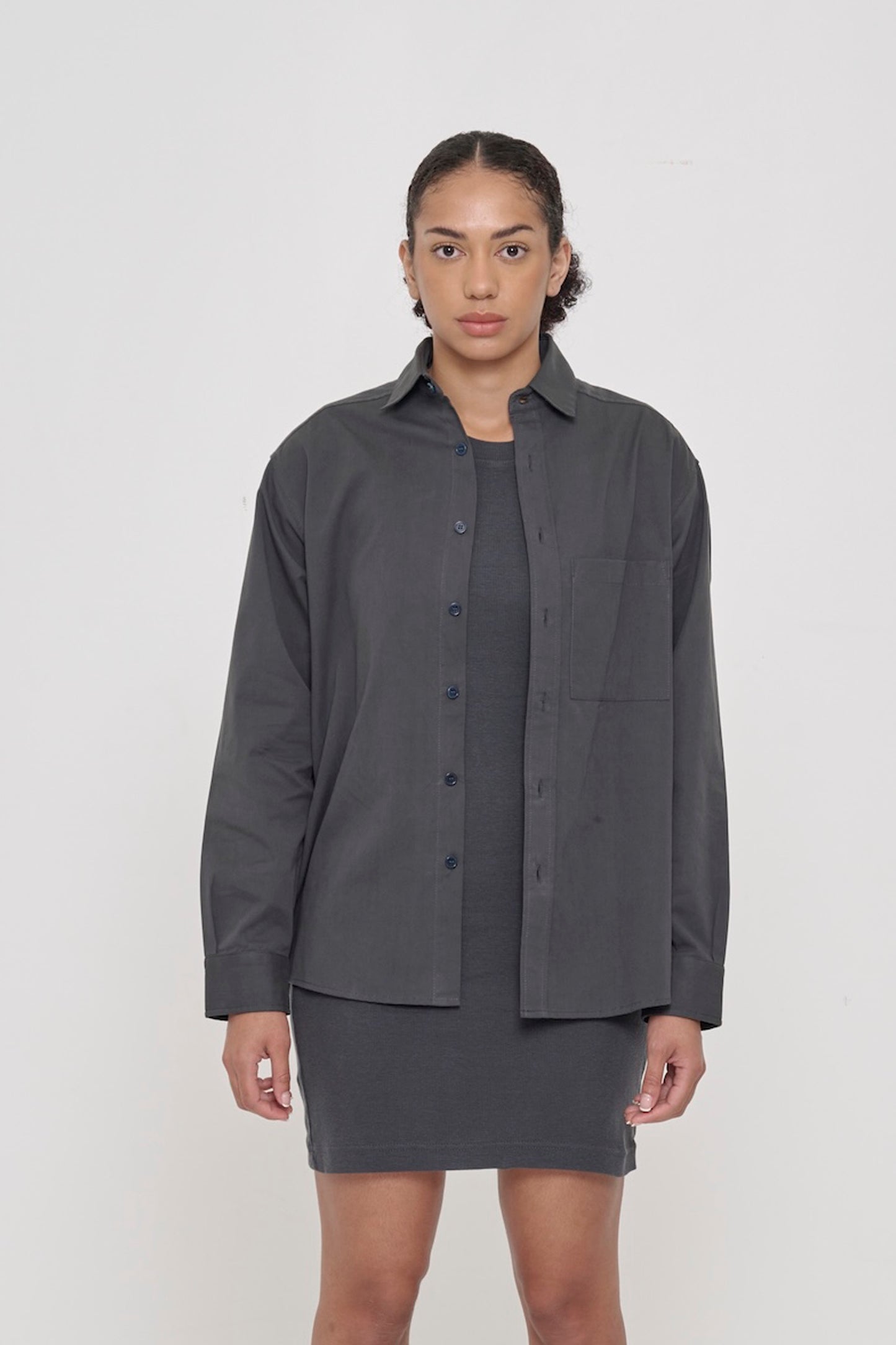 Person wearing a Slate Peach Fuzz Twill Button Up Shirt, worn open over a Slate Rib Dress. 