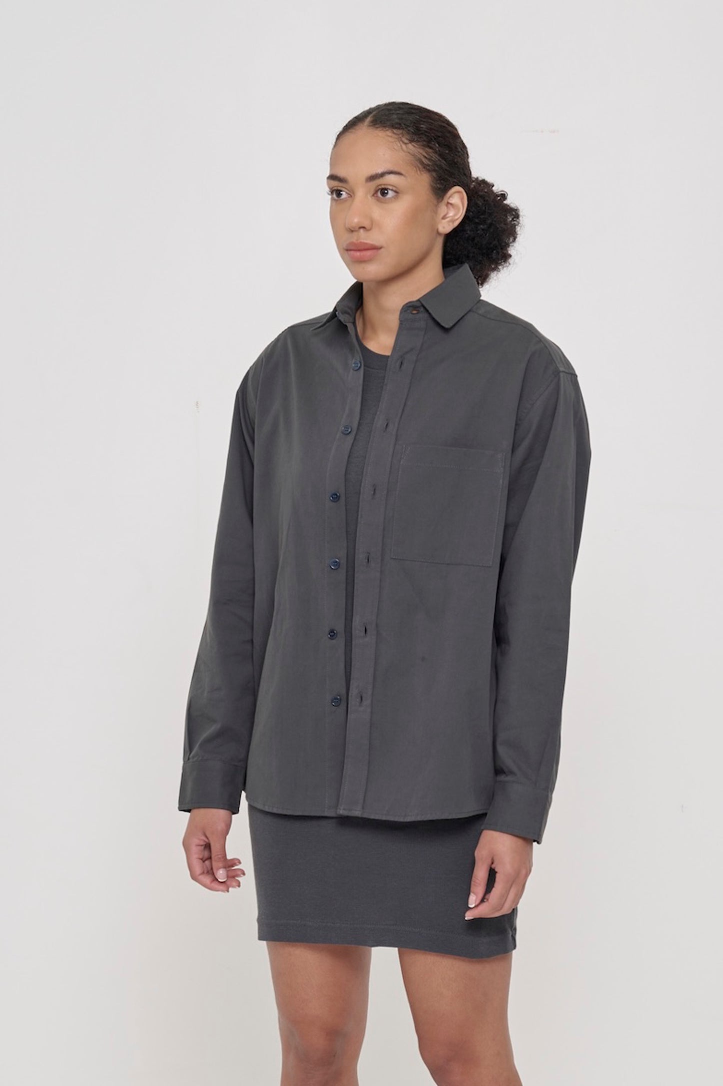 3/4 front view of a person in a Slate Peach Fuzz Twill Button Up Shirt, showcasing its sleeves, buttons, and chest pocket.
