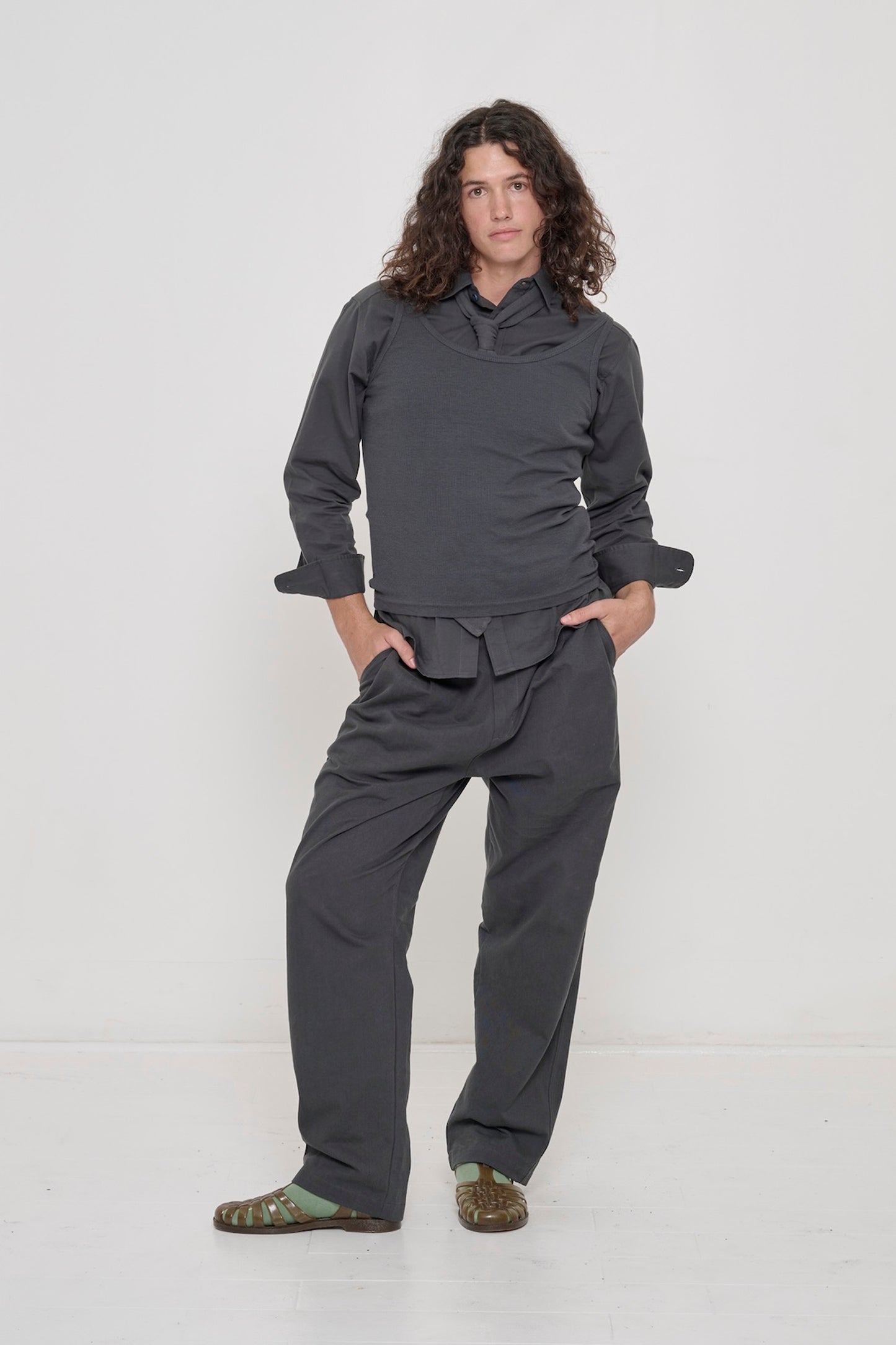 A person wearing a Slate Peach Fuzz Twill Button Up Shirt, hands in pockets of matching Cotton Twill Life Uniform Pants. 
