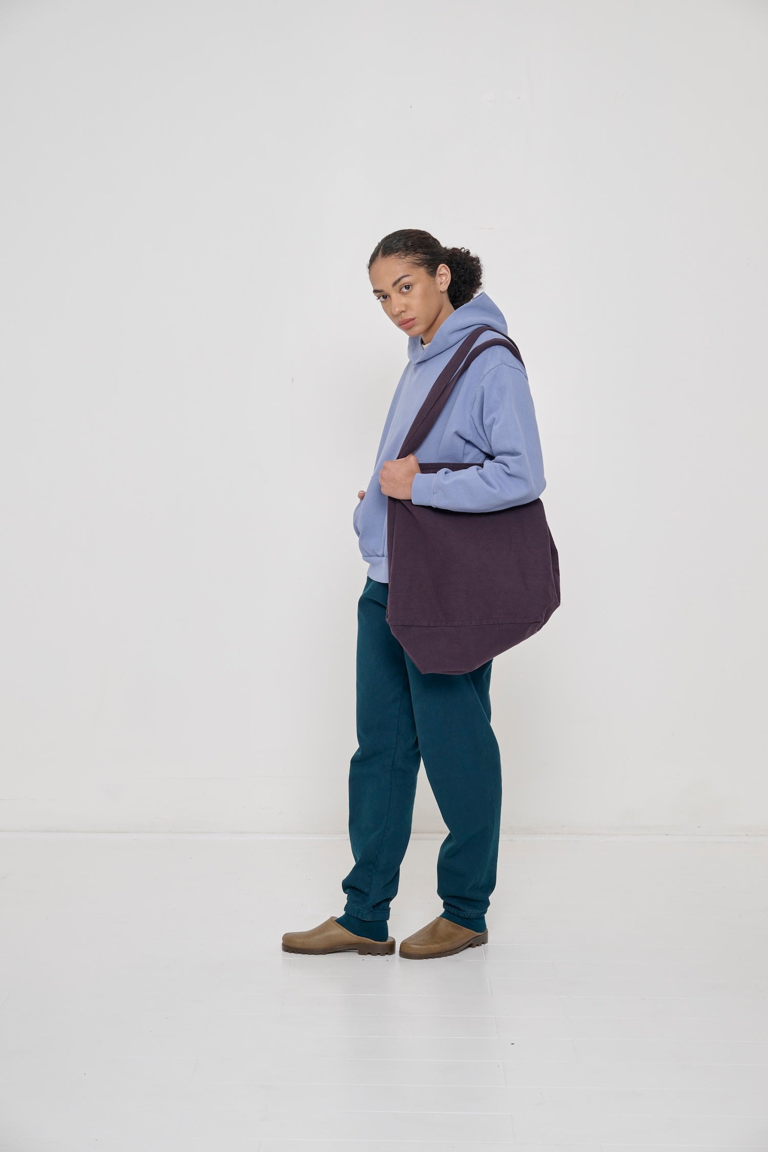 Model wearing Hemp Plasticana Opana Mules with Juniper Trash Sweatpants  and Juniper Squishy Socks.