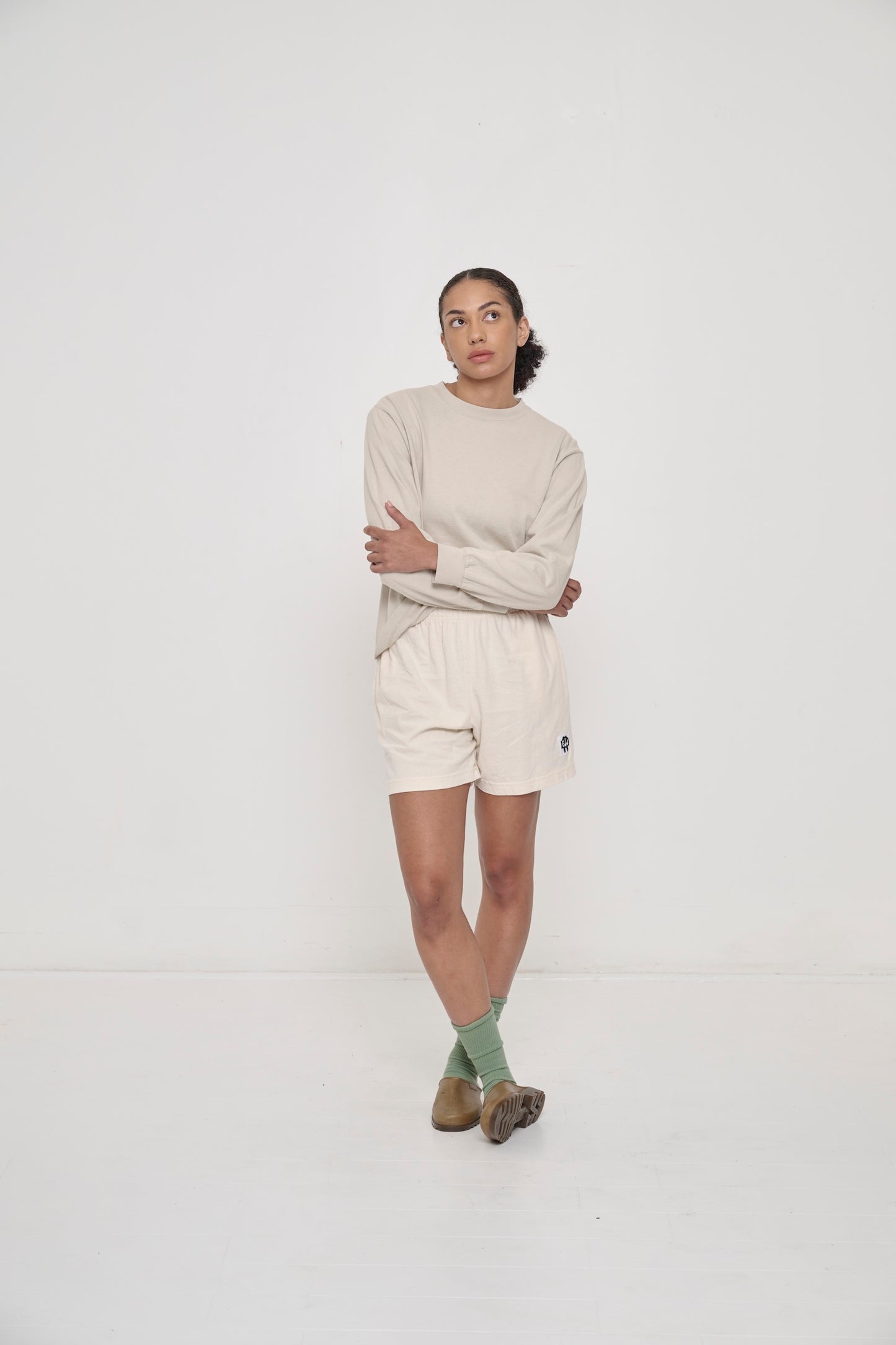 Model wearing Hemp Plasticana Opana Mules with Scour Everyday Shorts and Wasabi Squishy Socks.