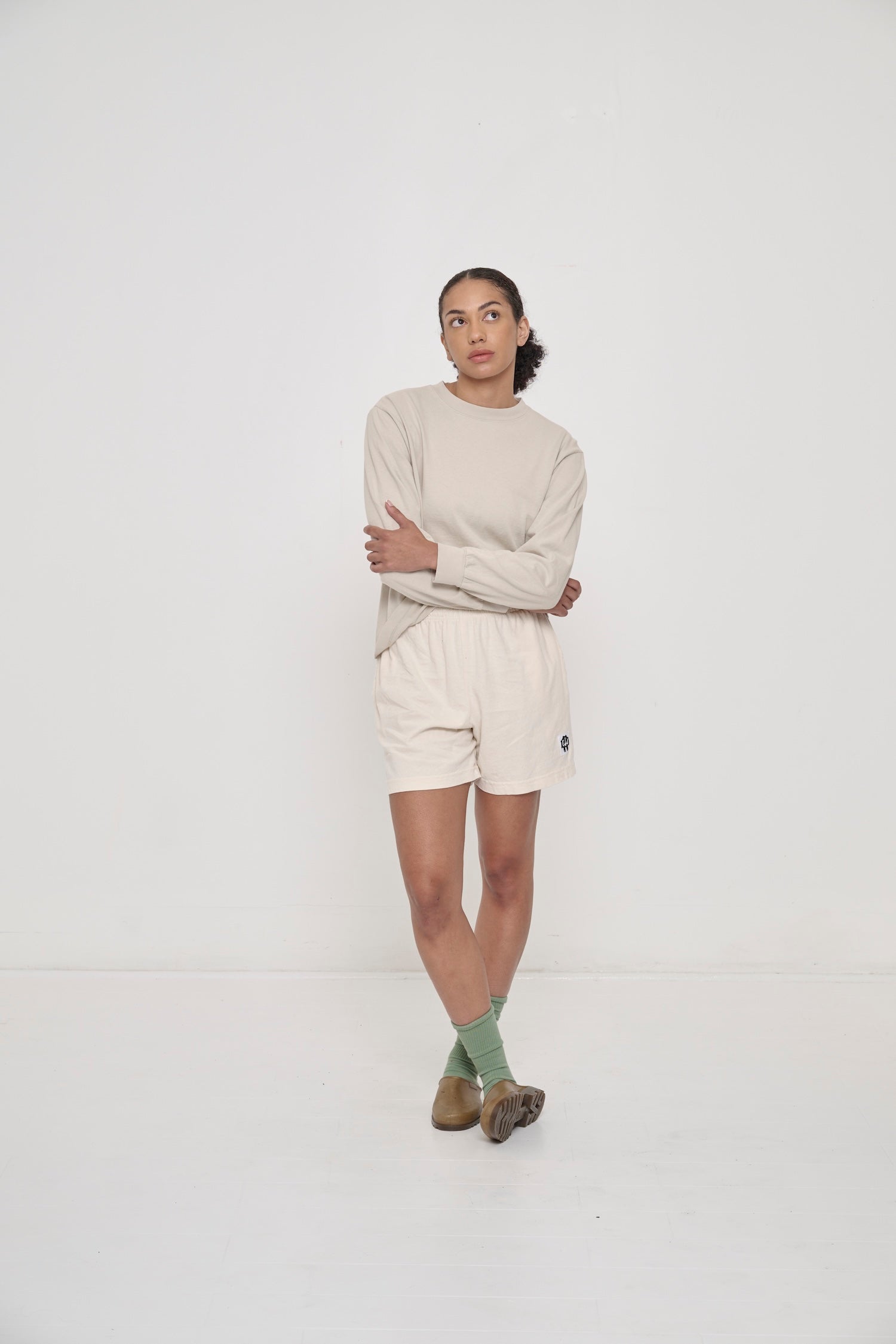 Model wearing Hemp Plasticana Opana Mules with Scour Everyday Shorts and Wasabi Squishy Socks.