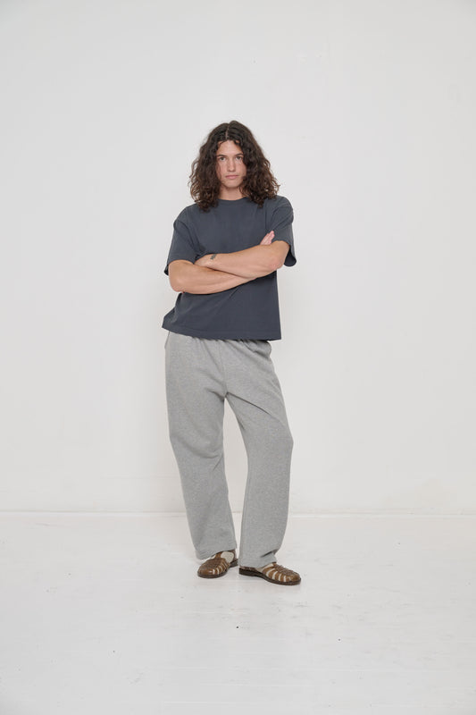 Model wearing Hemp Plasticana Sandana Jelly Sandal with Heather Sweatpants and Oat Spring Socks.