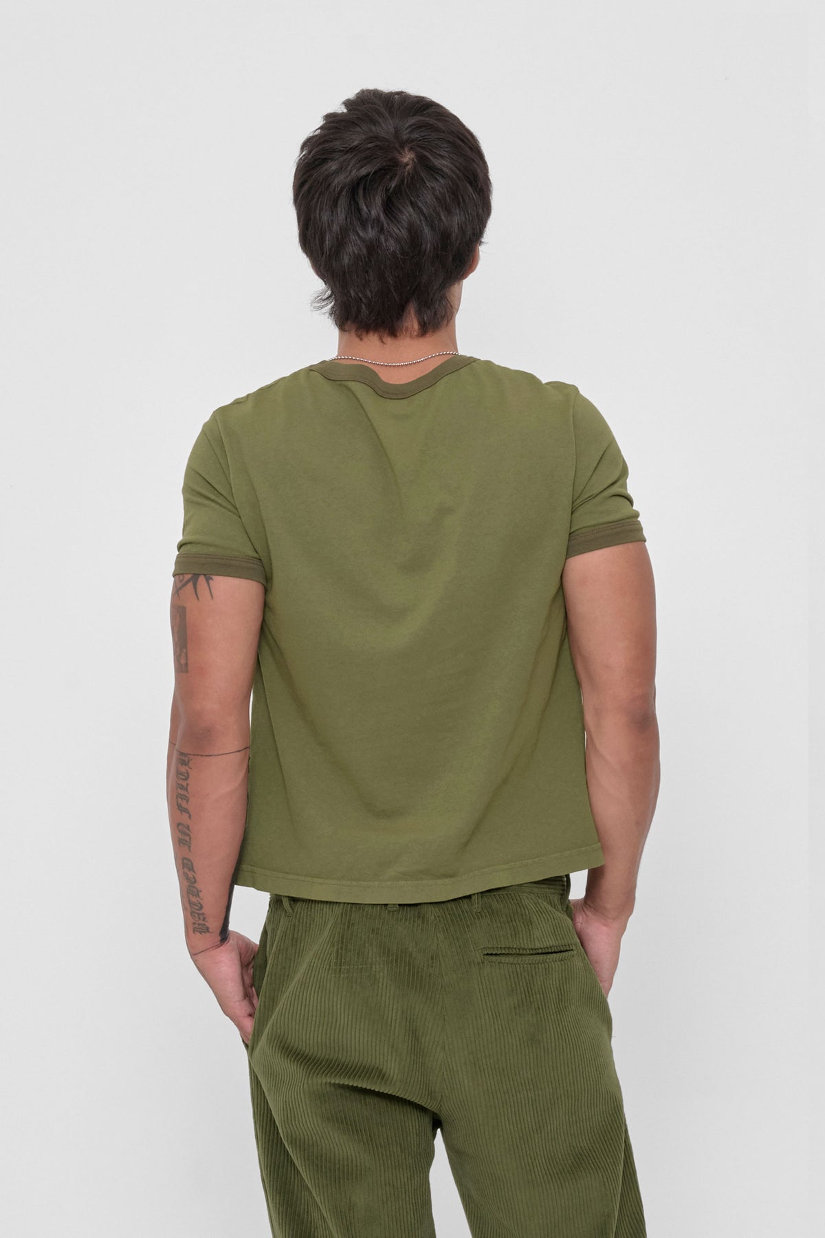 Ringer Trash Tee in Olive – back view on model