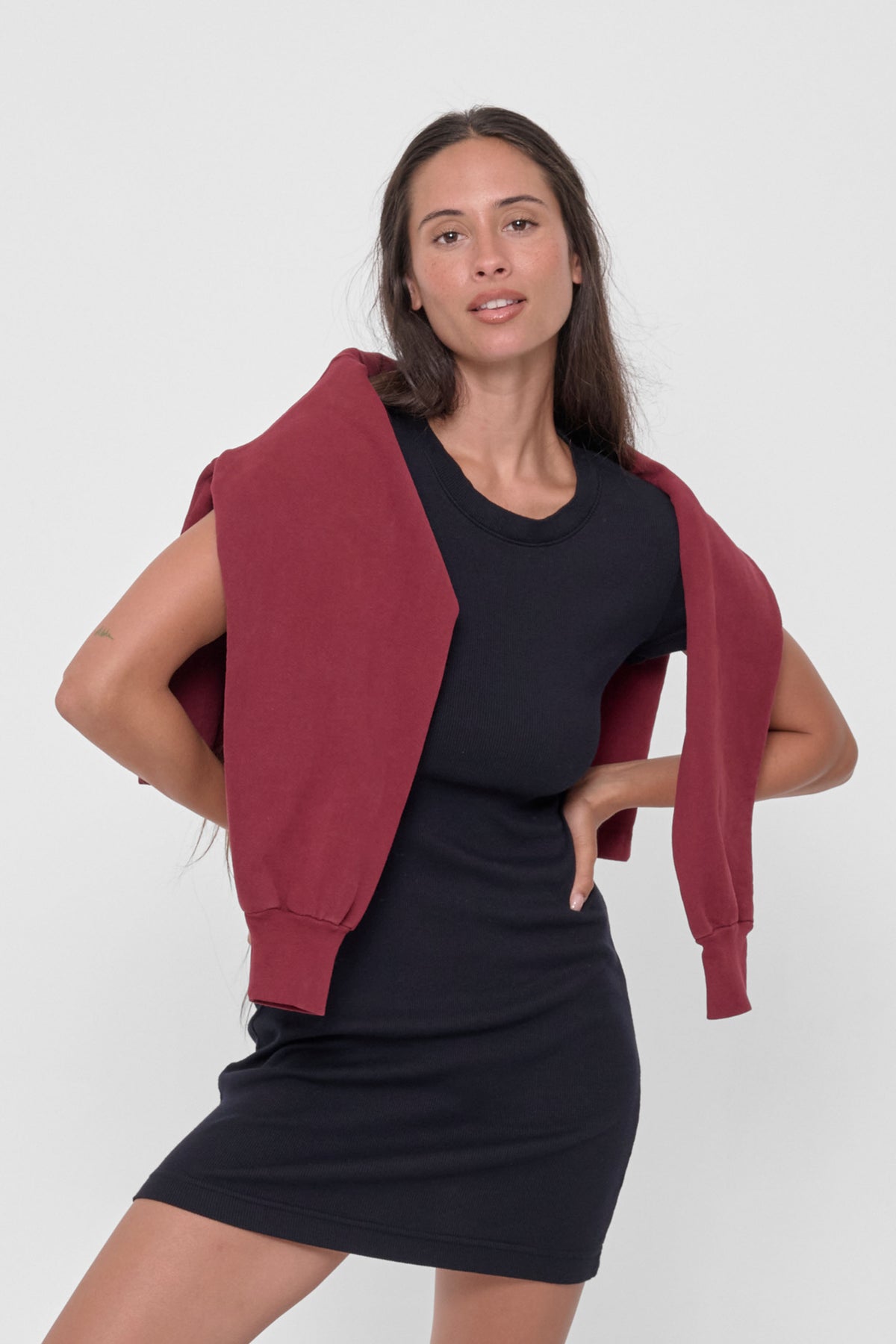 Rib Dress in Black – front view, with Garnet Trash Crewneck wrapped around model's body