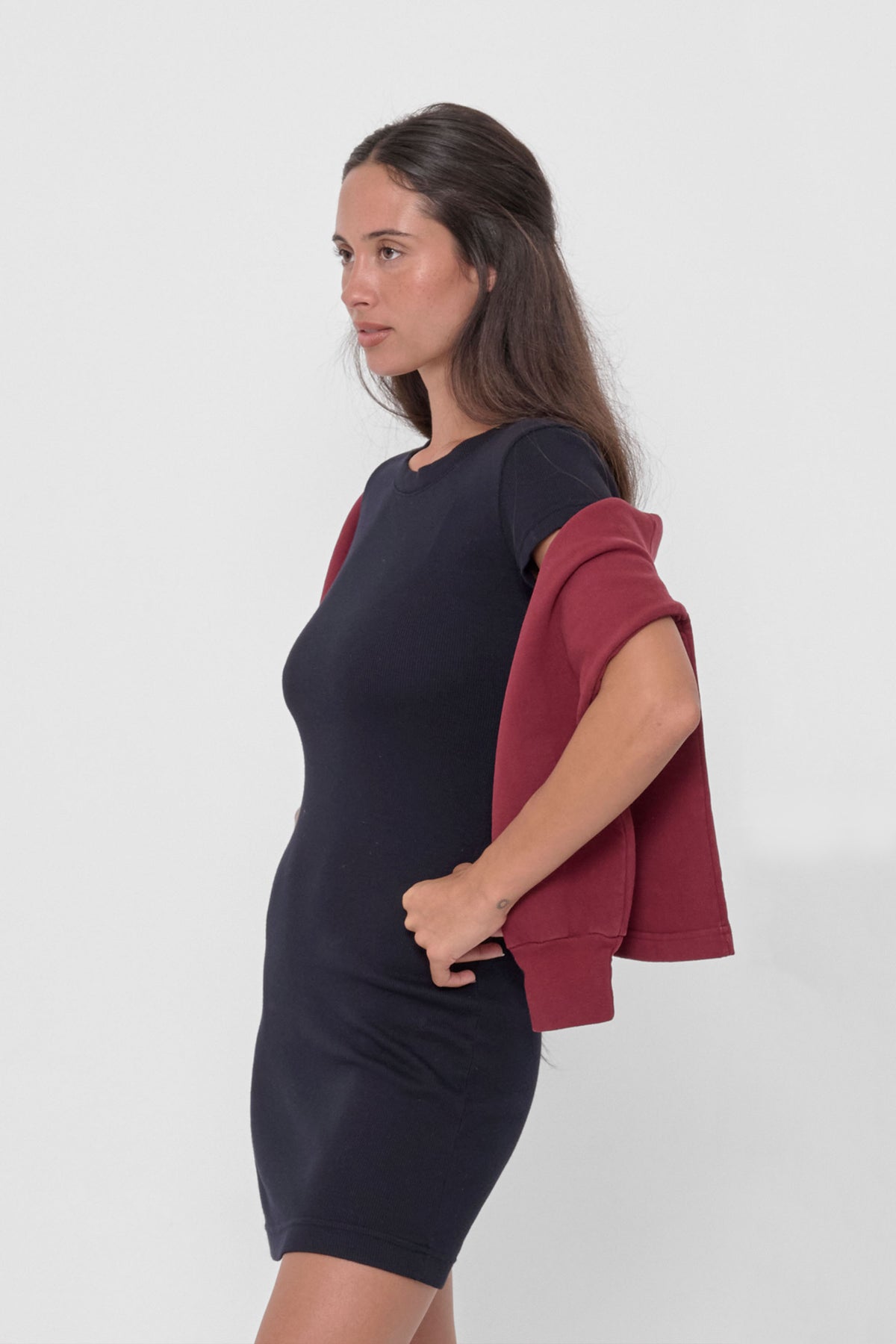 Rib Dress in Black – side view, with Garnet Trash Crewneck wrapped around the back of model's body