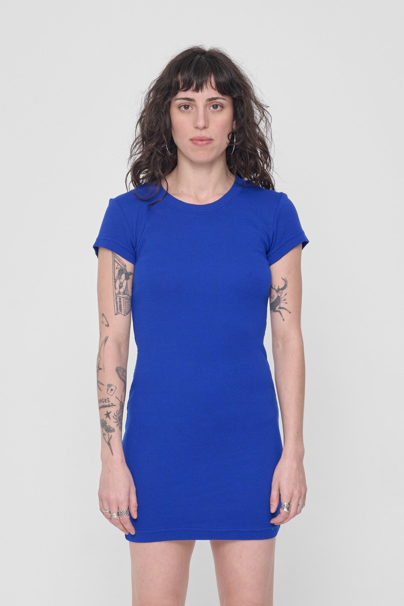 A 5'6" woman in a size S Lapis Rib Dress. Bottom hem ends upper mid-thigh.