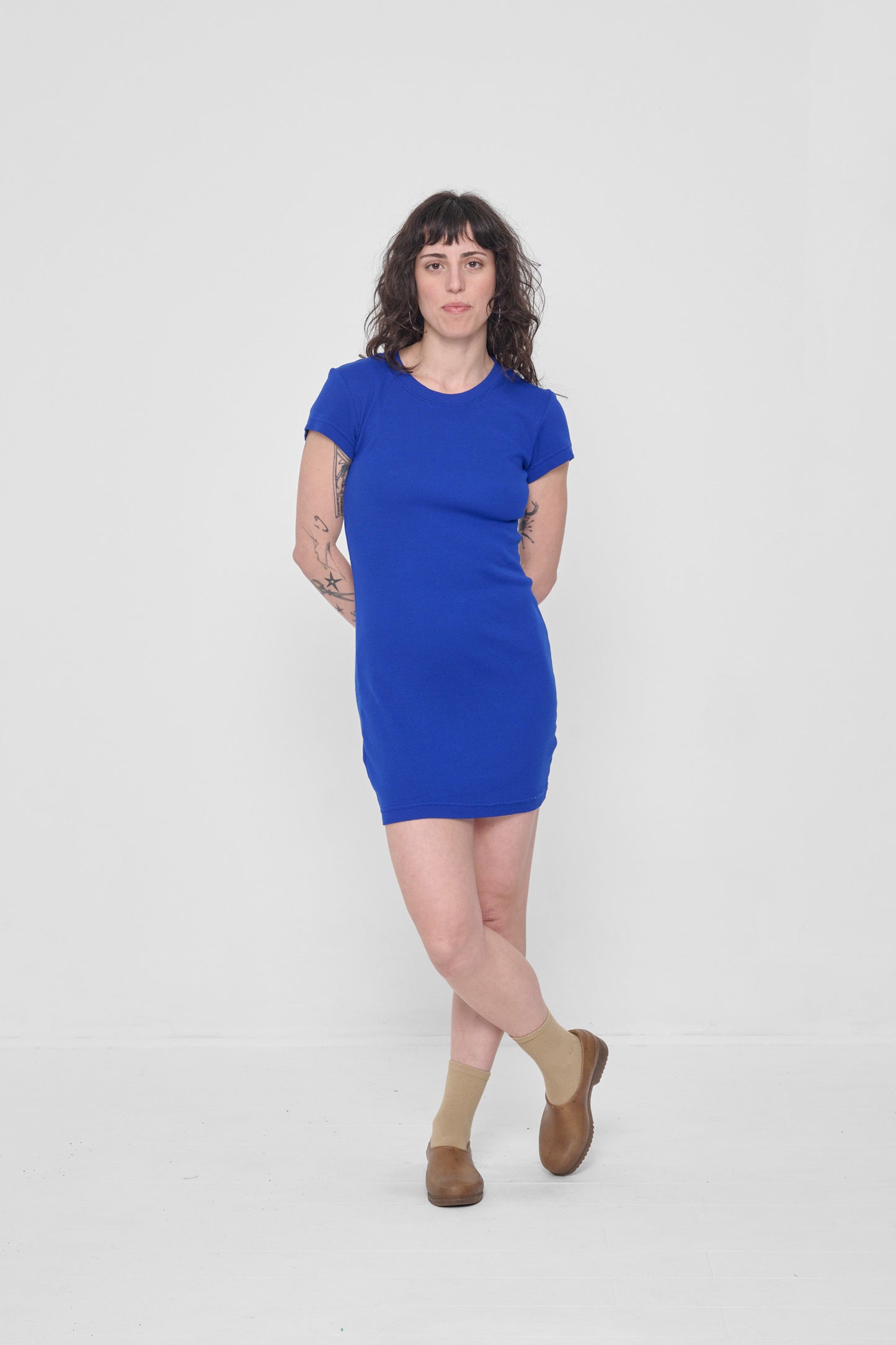 Casually standing to show the fabric drape and short length.