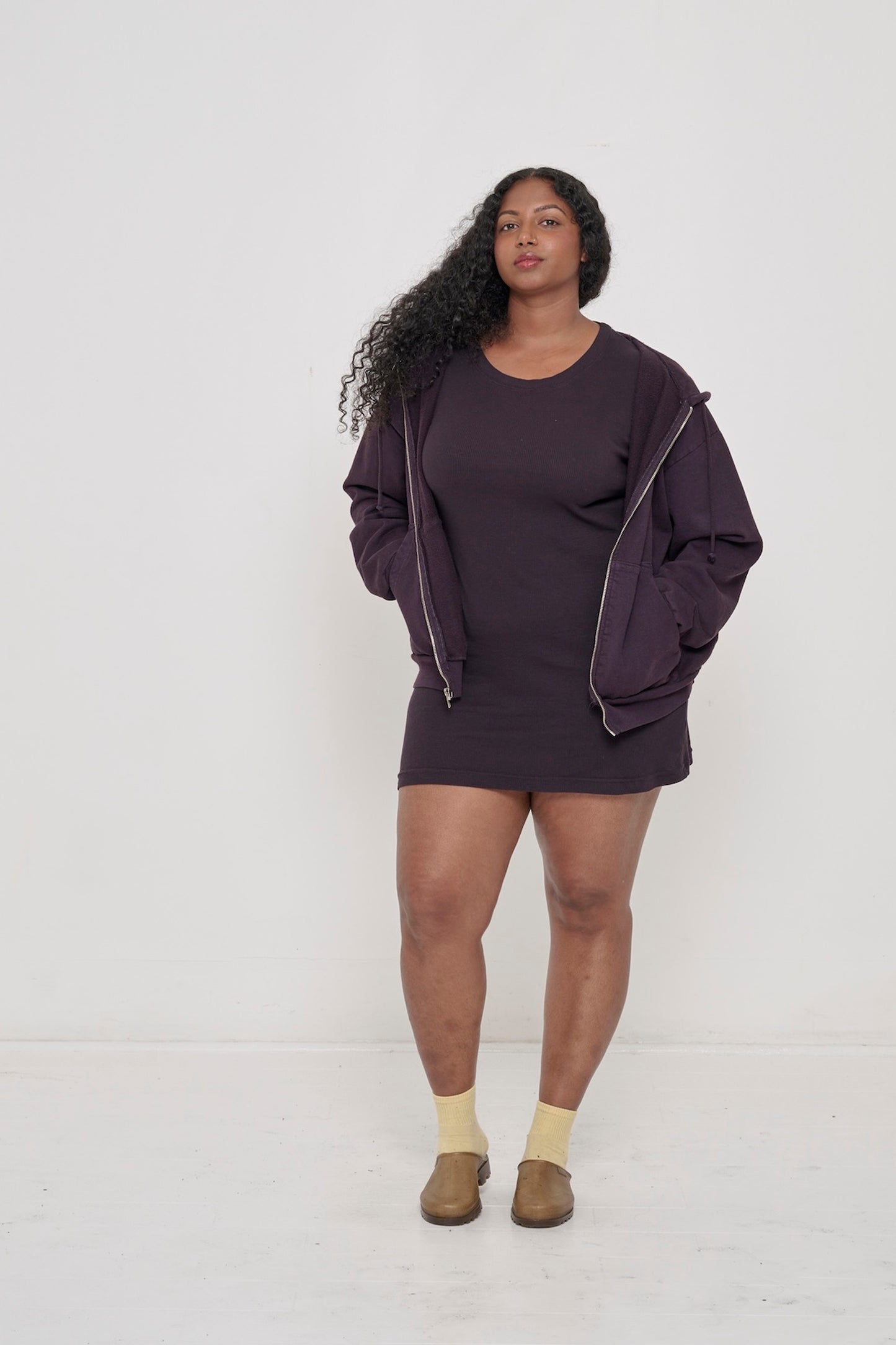Woman in a Mulberry Rib Dress with matching Trash Zip Up Hoodie worn open over the top.
