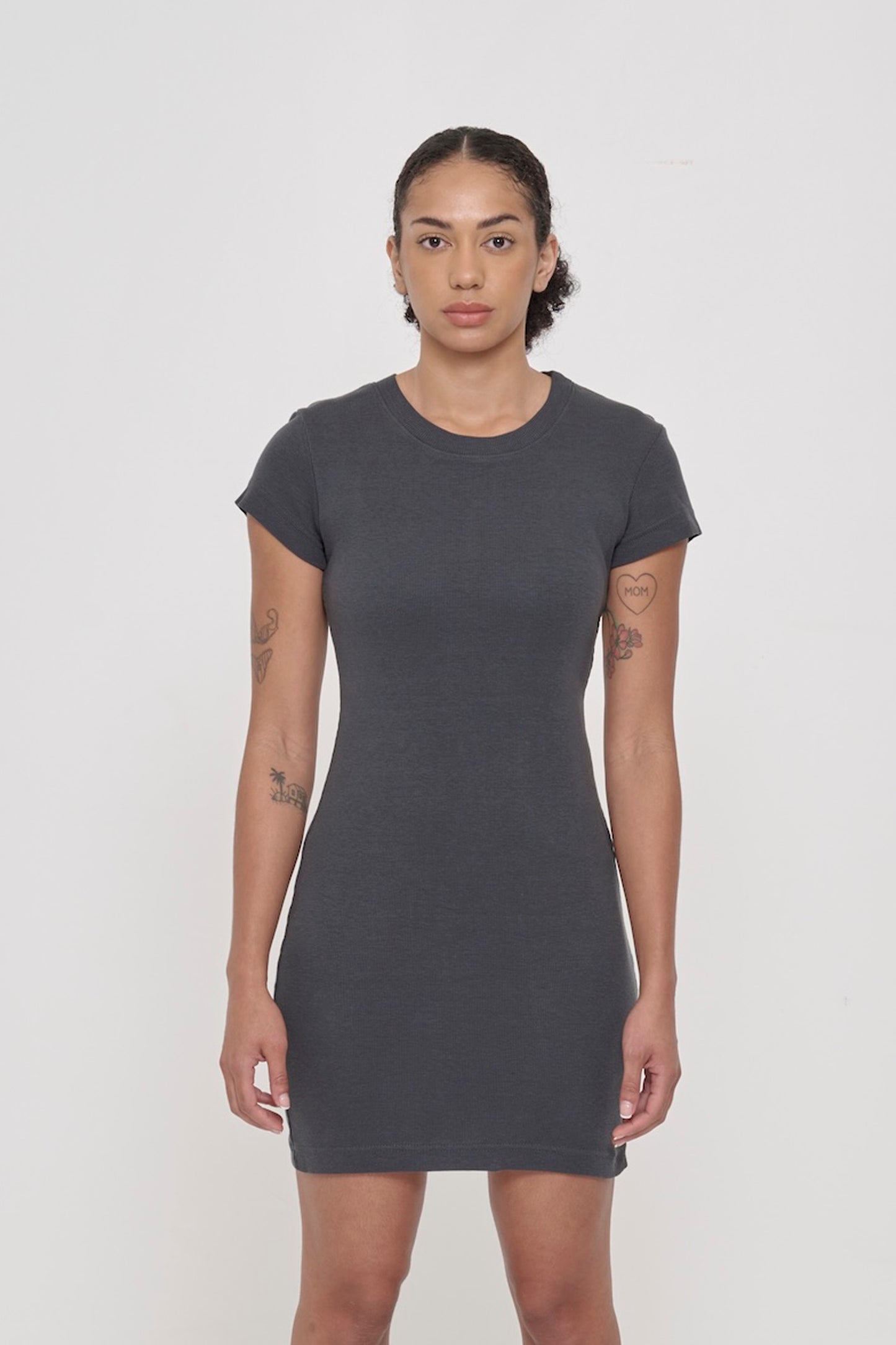 A 5'8" woman wearing a Slate Rib Dress in size M. Bottom hem hit mid-thigh.