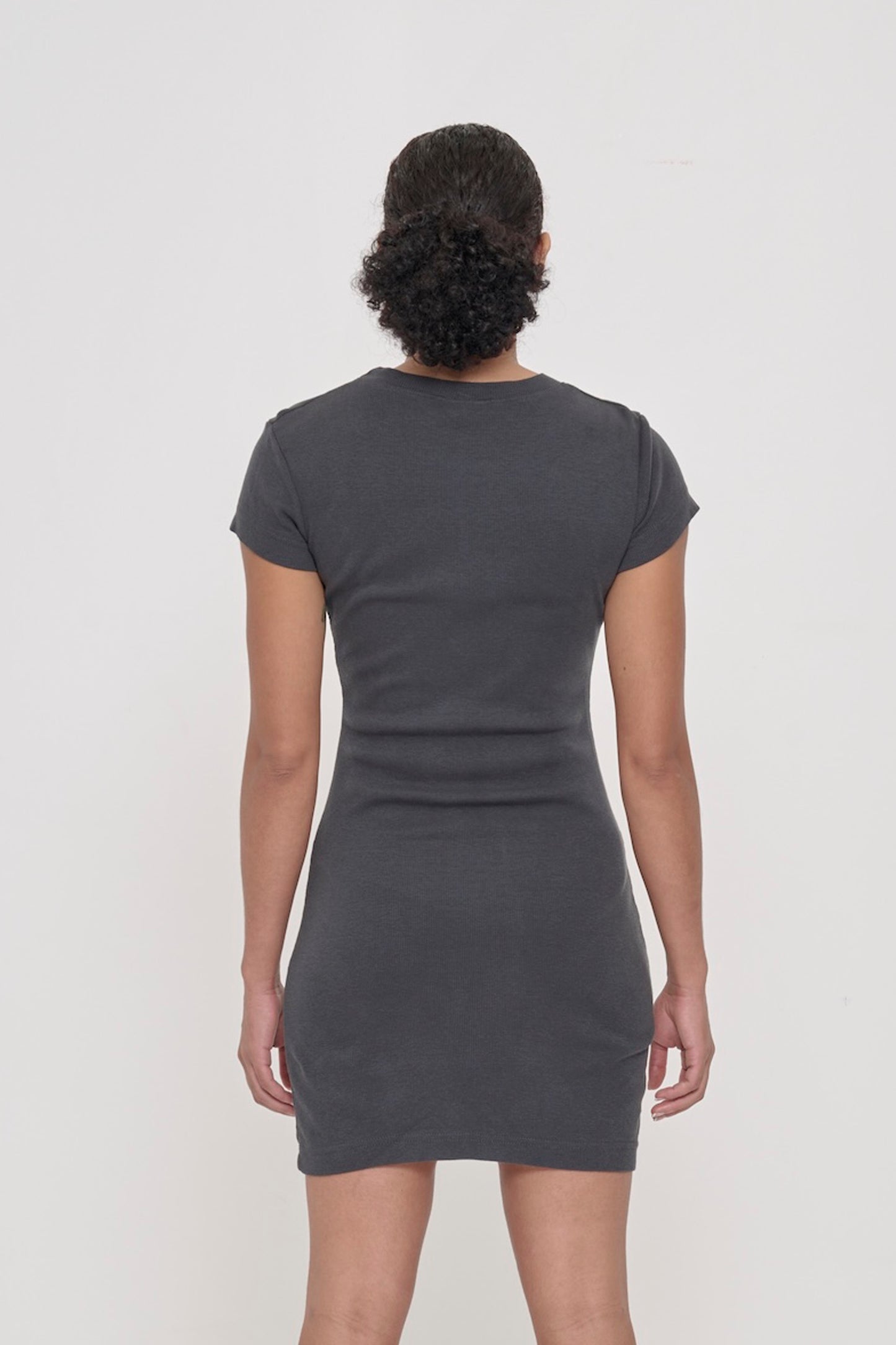 Back view of a woman wearing a Slate Rib Dress showing the formfitting silhouette.
