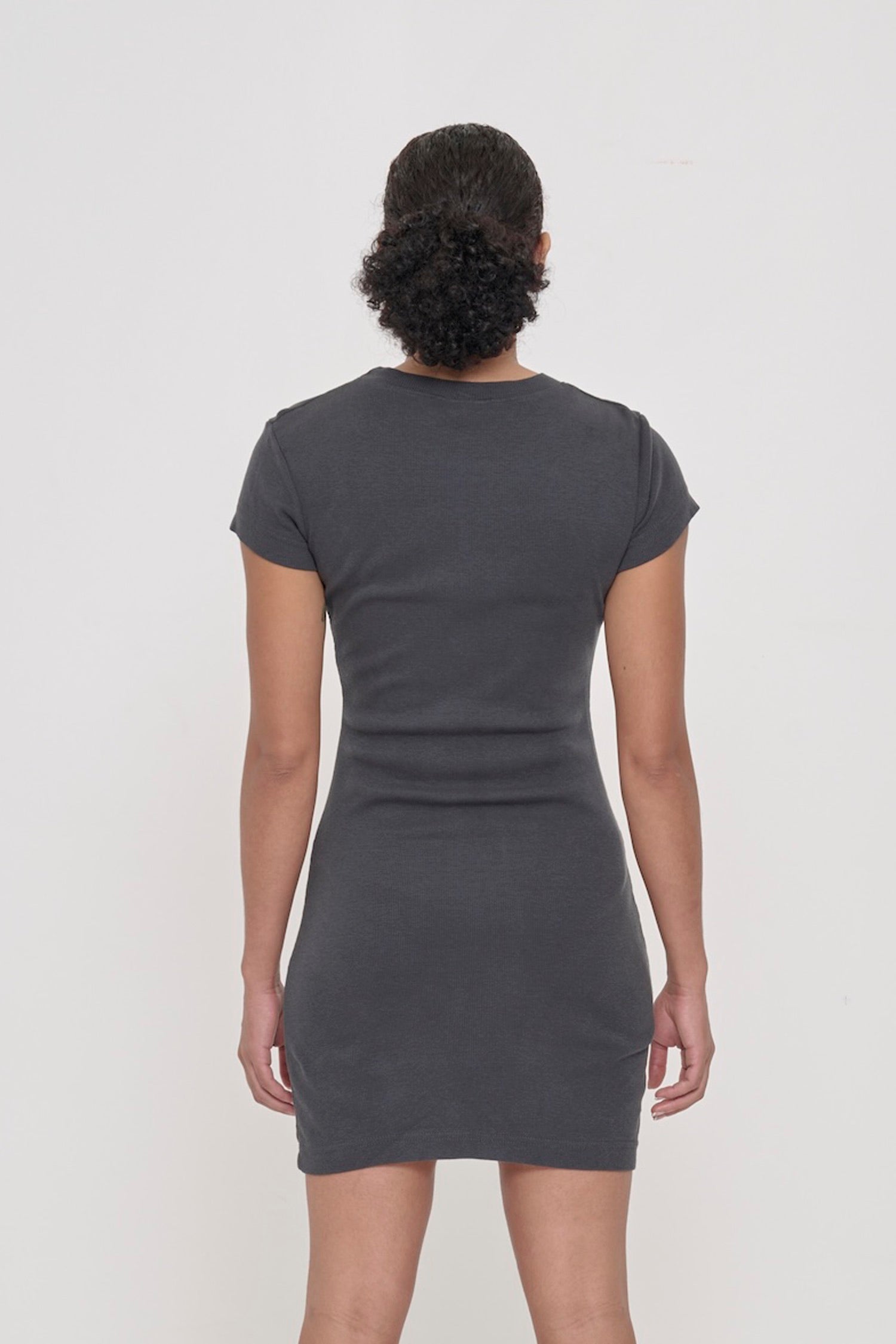 Back view of a woman wearing a Slate Rib Dress showing the formfitting silhouette.