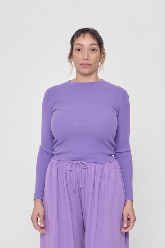 5'4" woman in a size S Carpe Diem Rib Long Sleeve. Hem rests above her hip bones.