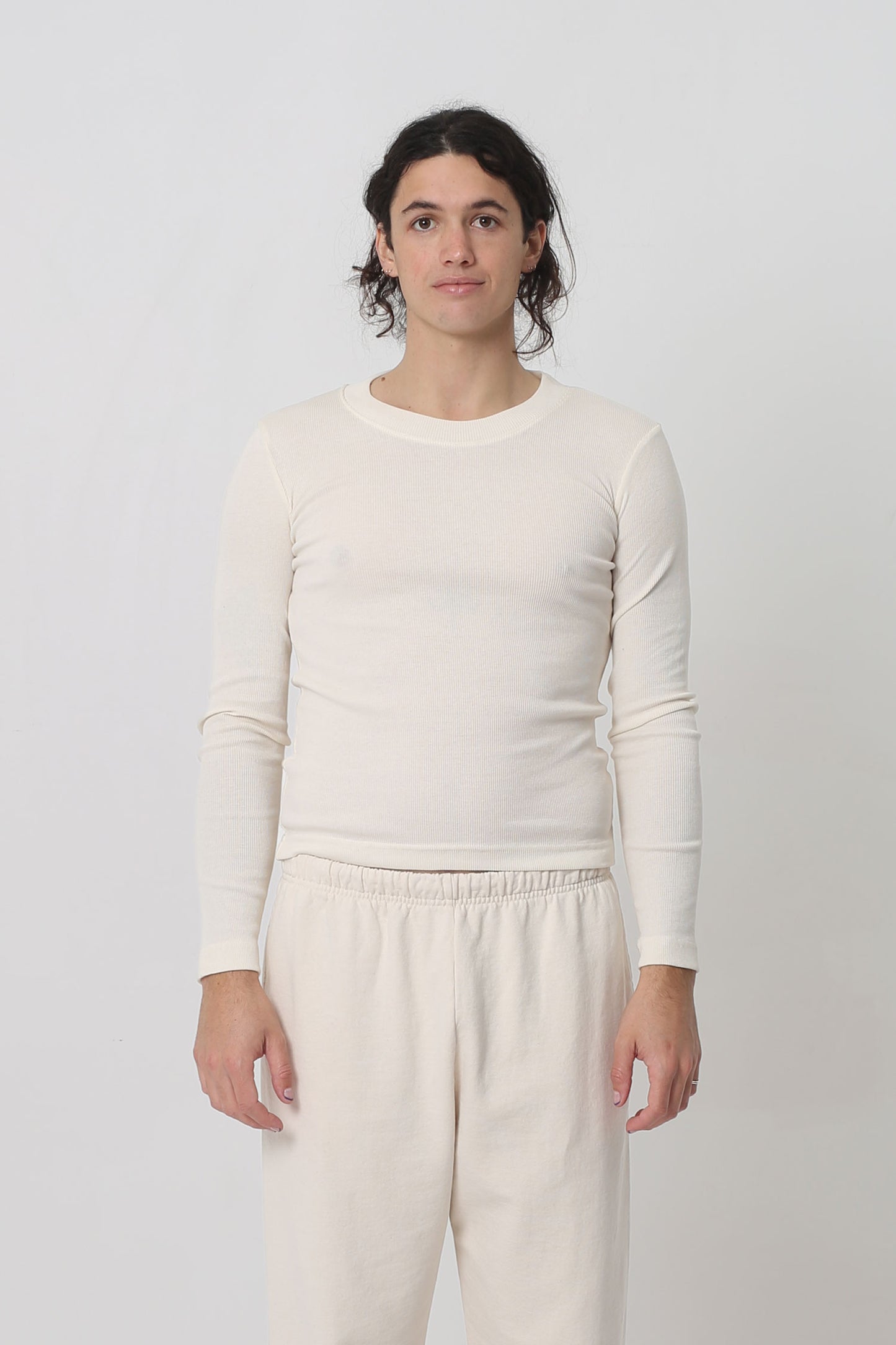 6' person in a size M Natural Rib Long Sleeve. Hem ends just above their hip bones.