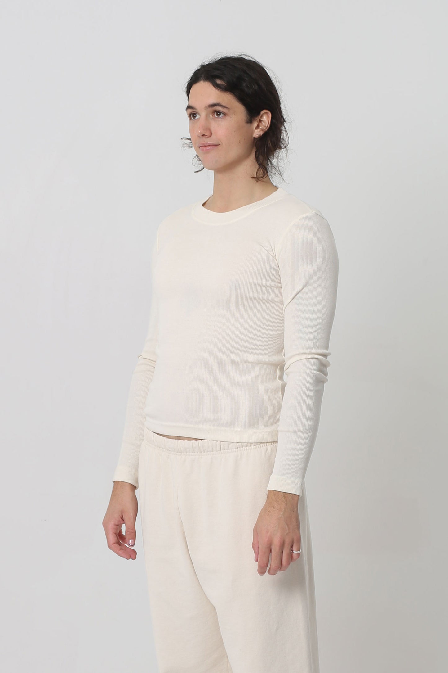 A person facing 45-degrees from the front shows side seams and fitted silhouette.