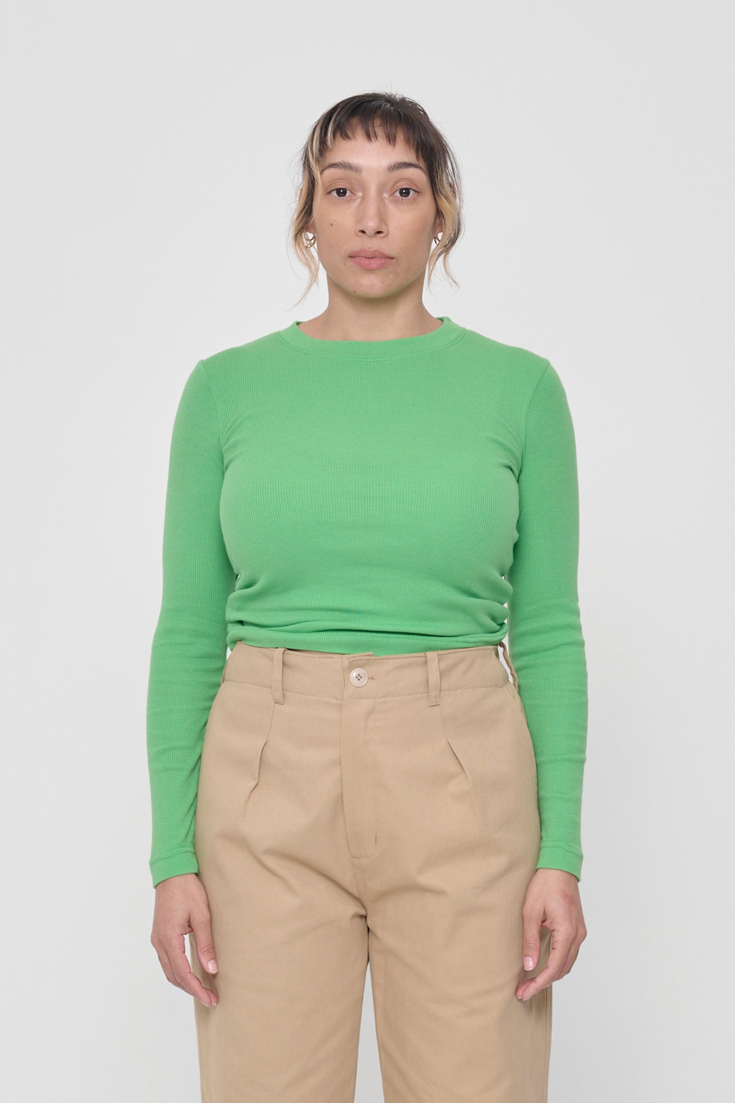 5'4" woman in a size S Nice Grass Rib Long Sleeve. Hem rests above her hip bones.