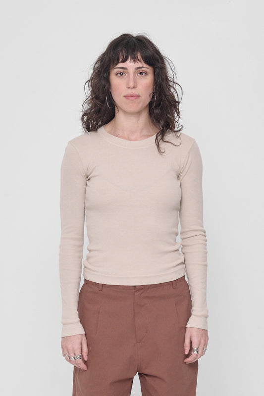A 5'6" woman in a size S Oat Rib Long Sleeve. Hem ends just above her hip bones.