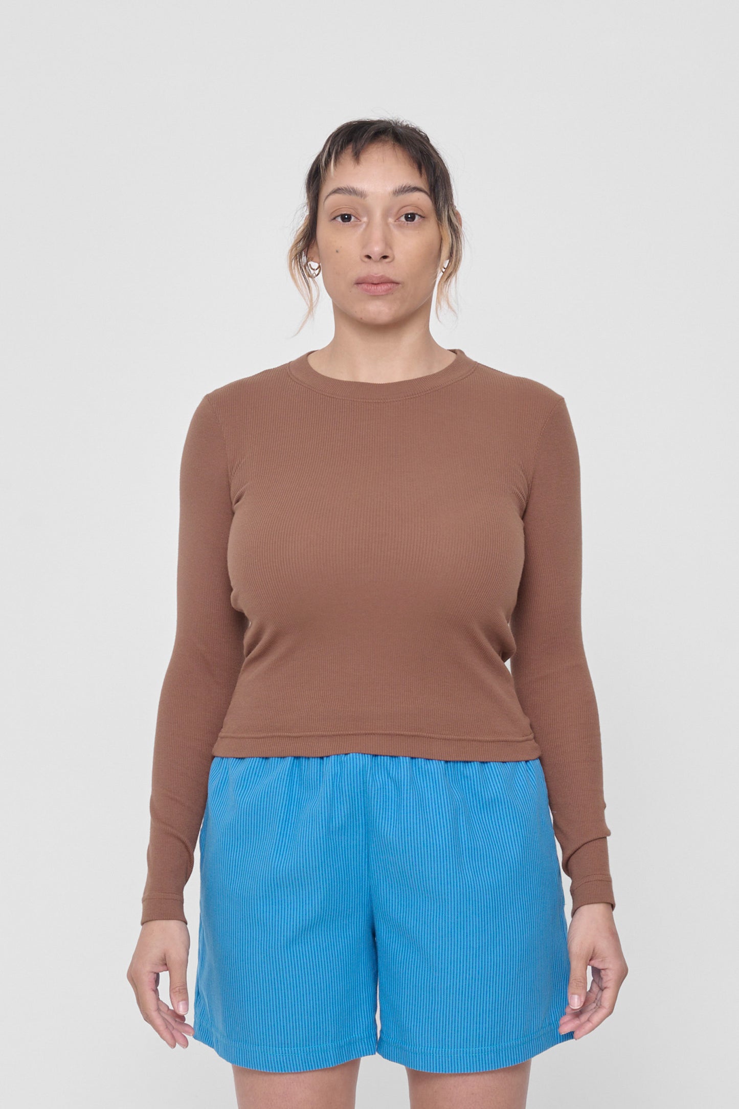 5'4" woman in a size S Potting Soil Rib Long Sleeve. Hem rests at her hip bones.