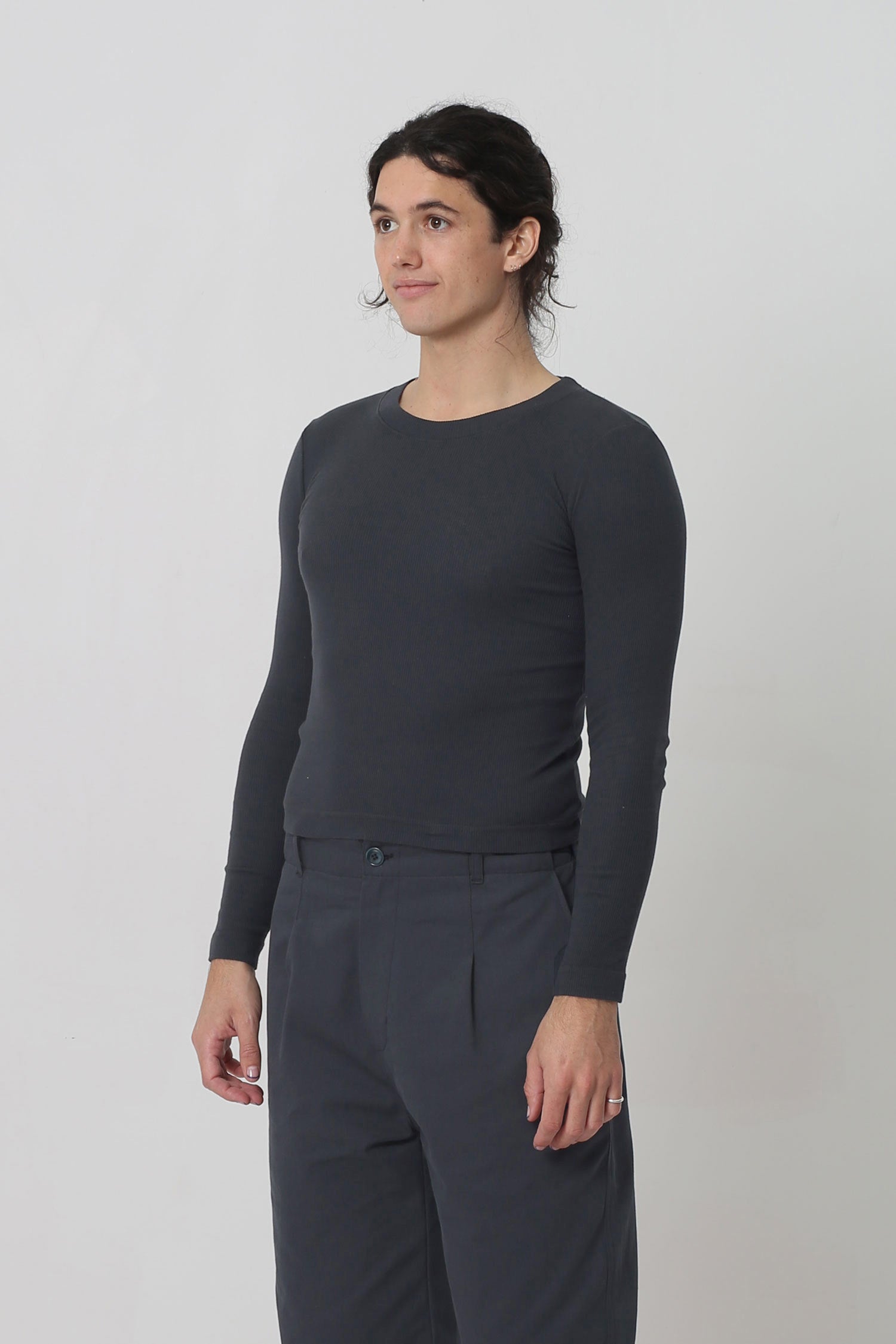 A person facing 45-degrees from the front shows side seams and fitted silhouette.