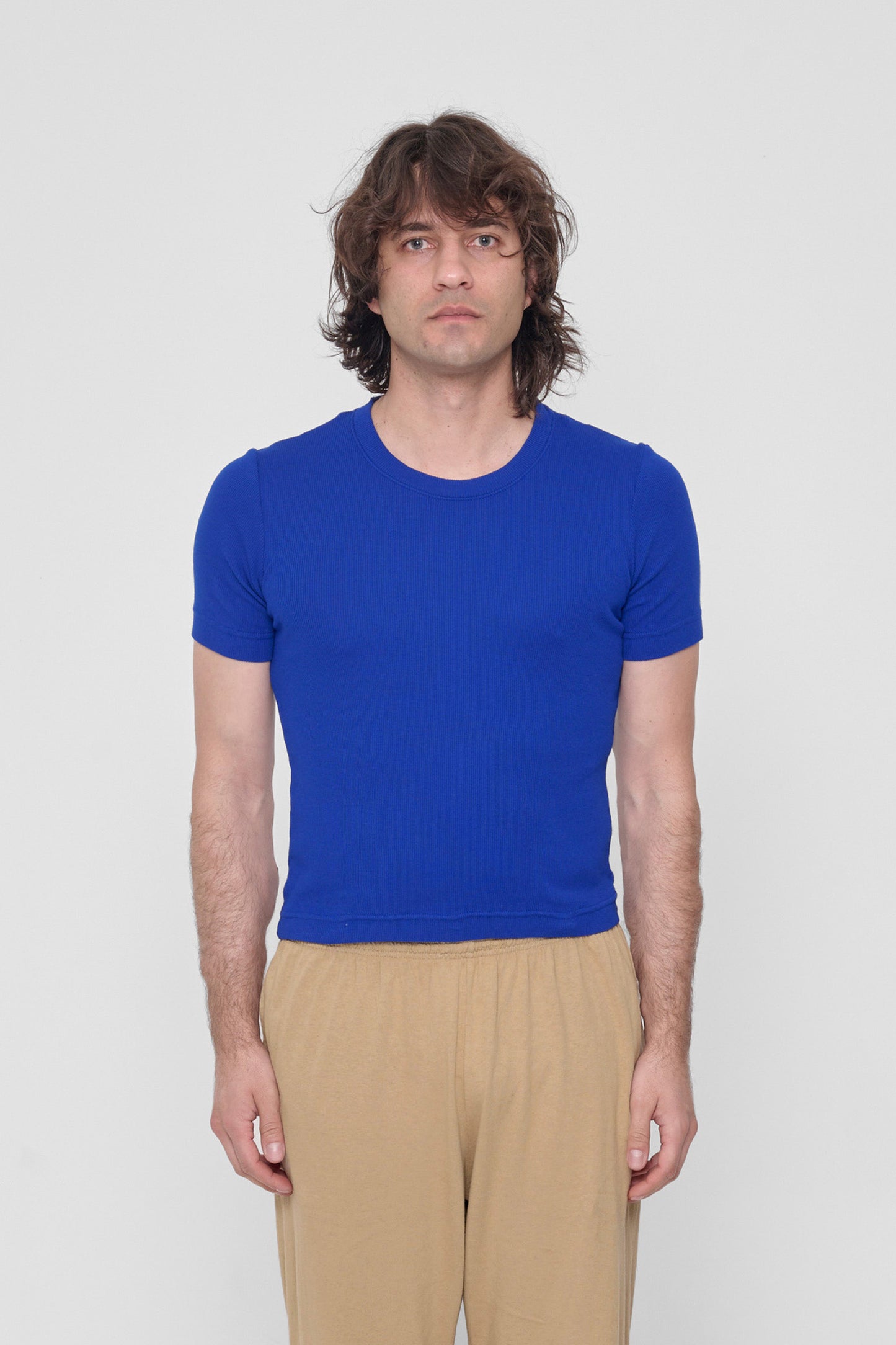 A 6'2" man in a size XL Lapis Rib Short Sleeve. Hem rests on his upper hips.