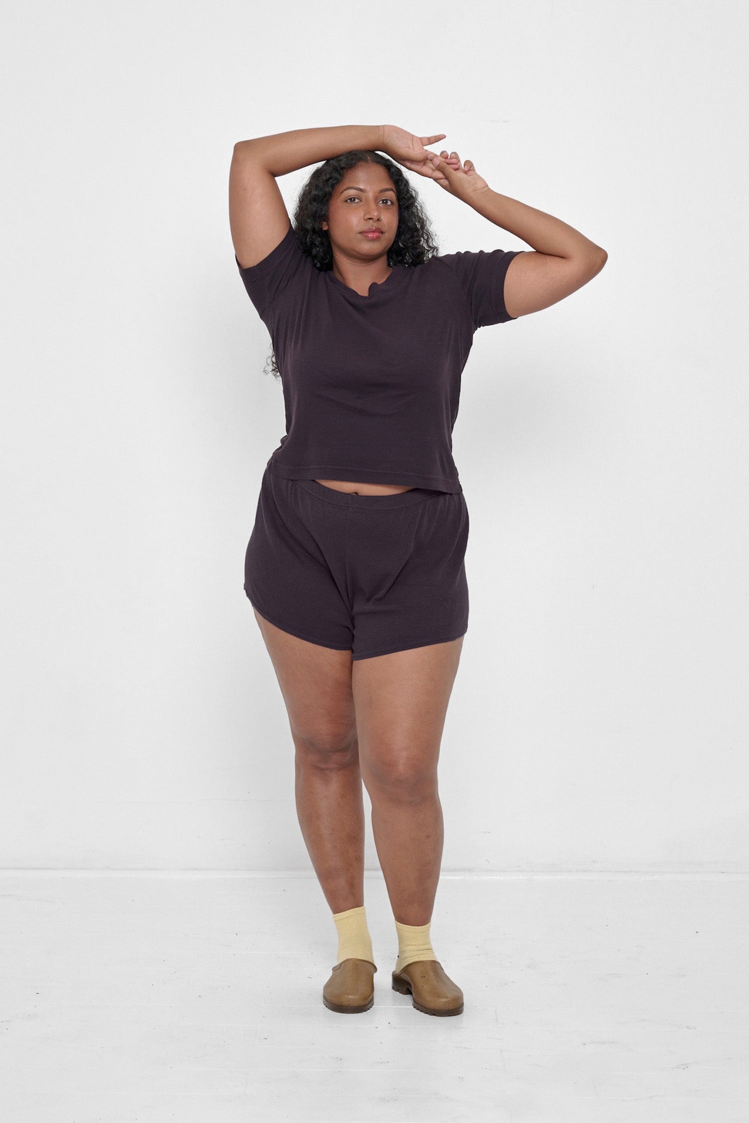 Woman in a Mulberry Rib Short Sleeve and matching Rib Shorts with Plasticana Opana Mules.