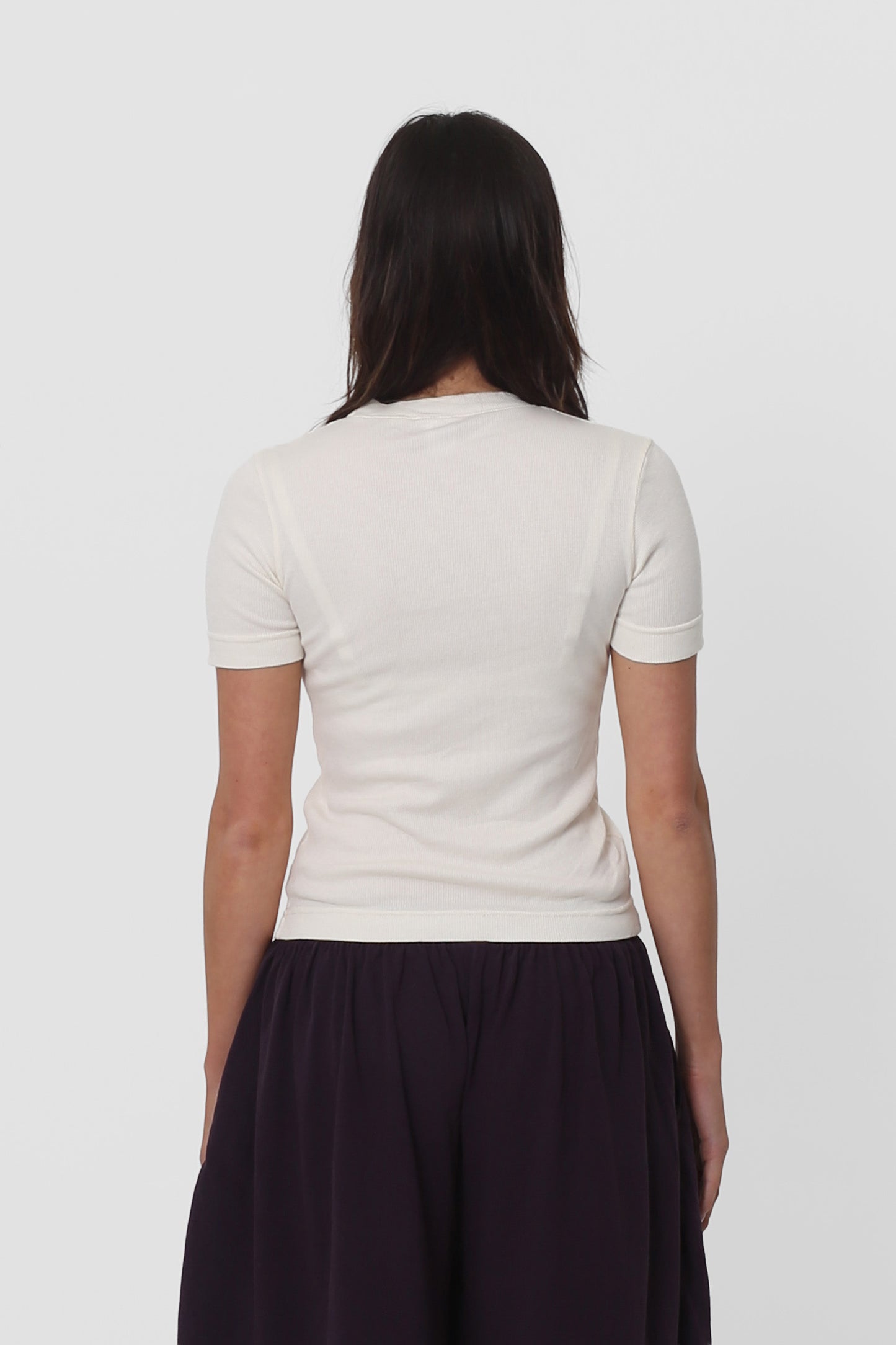 Back view: fitting smooth across her upper back and some relaxed folds shown across mid and lower back.