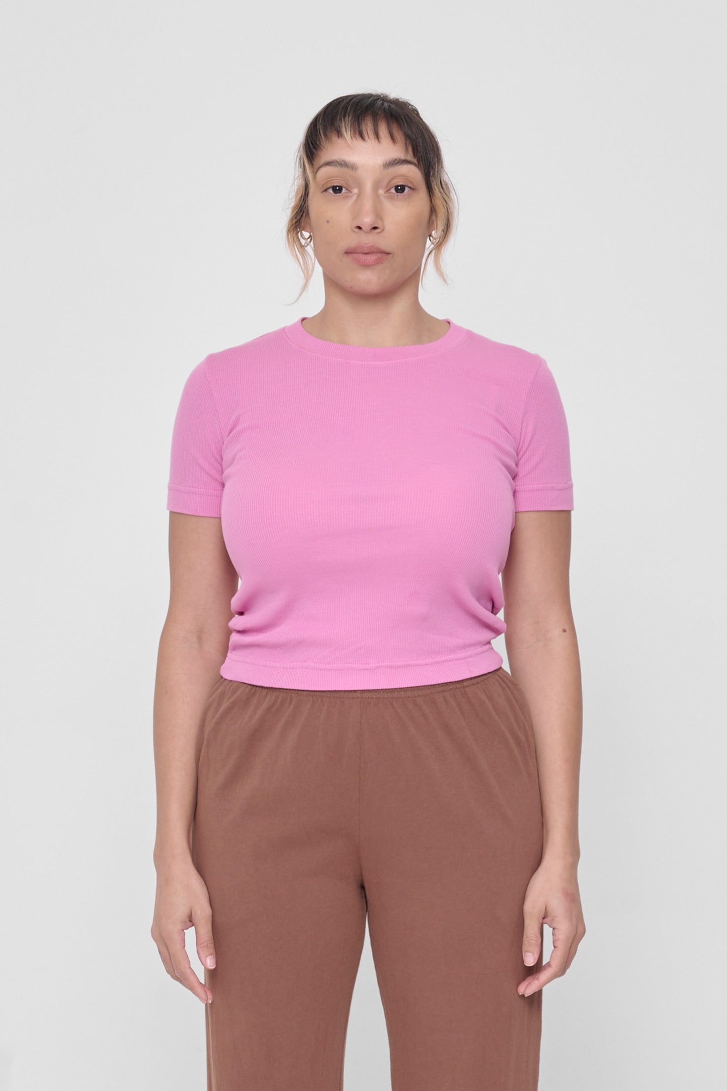 A 5'4" woman in a size S Pixie Rib Short Sleeve. Hem rests above her upper hips.