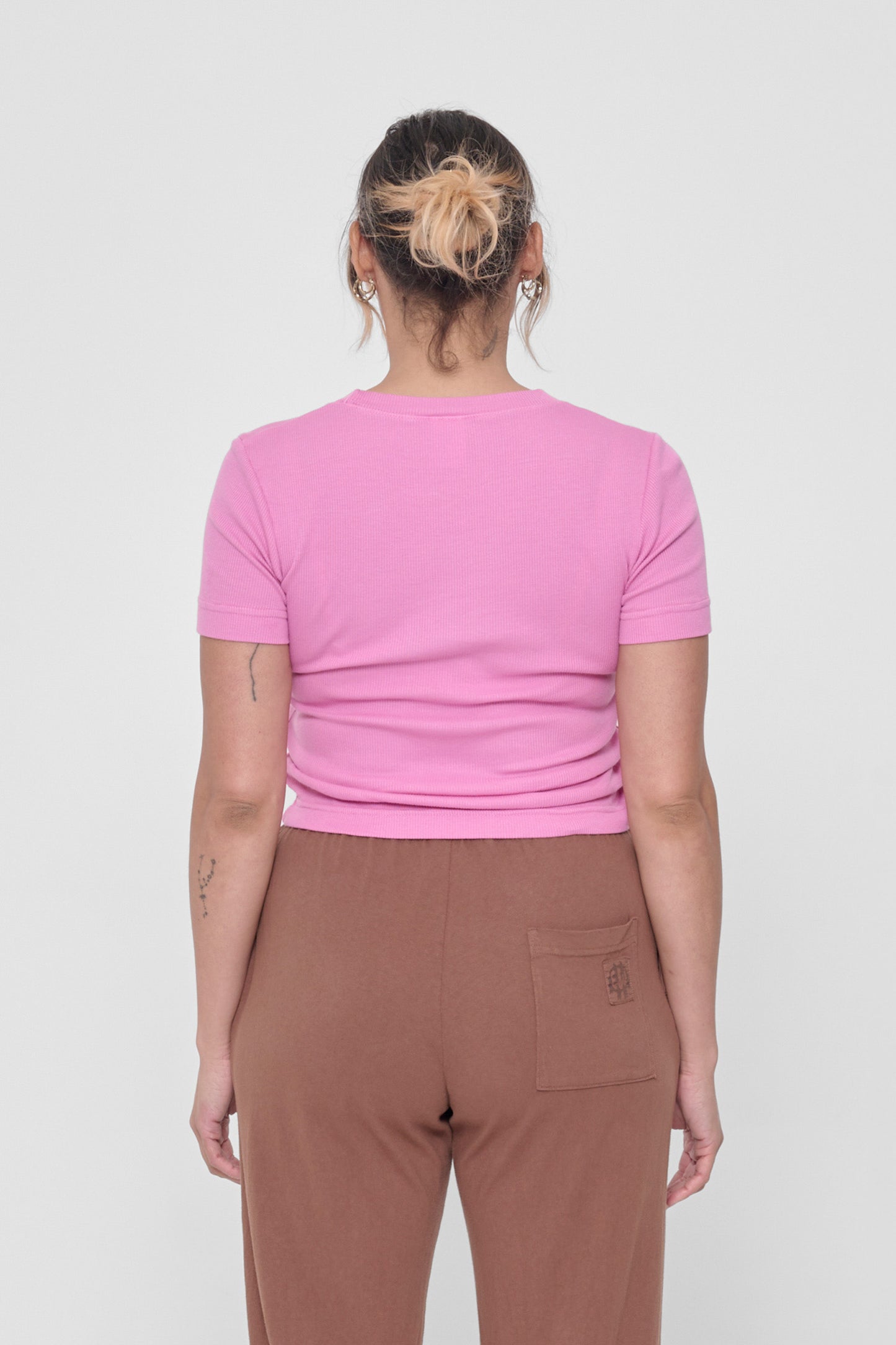 Back view: snug across upper back and some relaxed folds shown across mid and lower back.