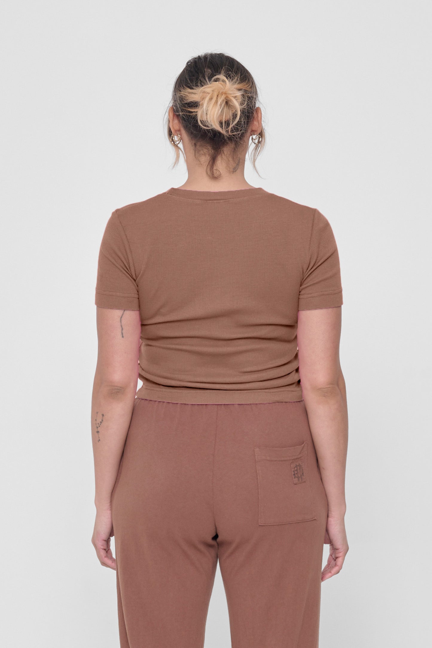 Back view: snug across upper back and some relaxed folds shown across mid and lower back.