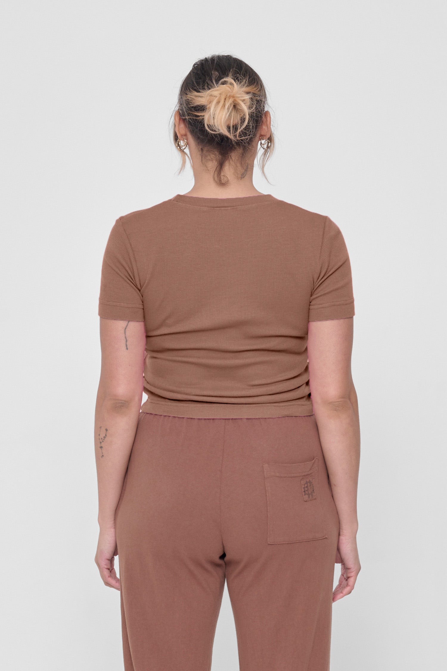 Back view: snug across upper back and some relaxed folds shown across mid and lower back.