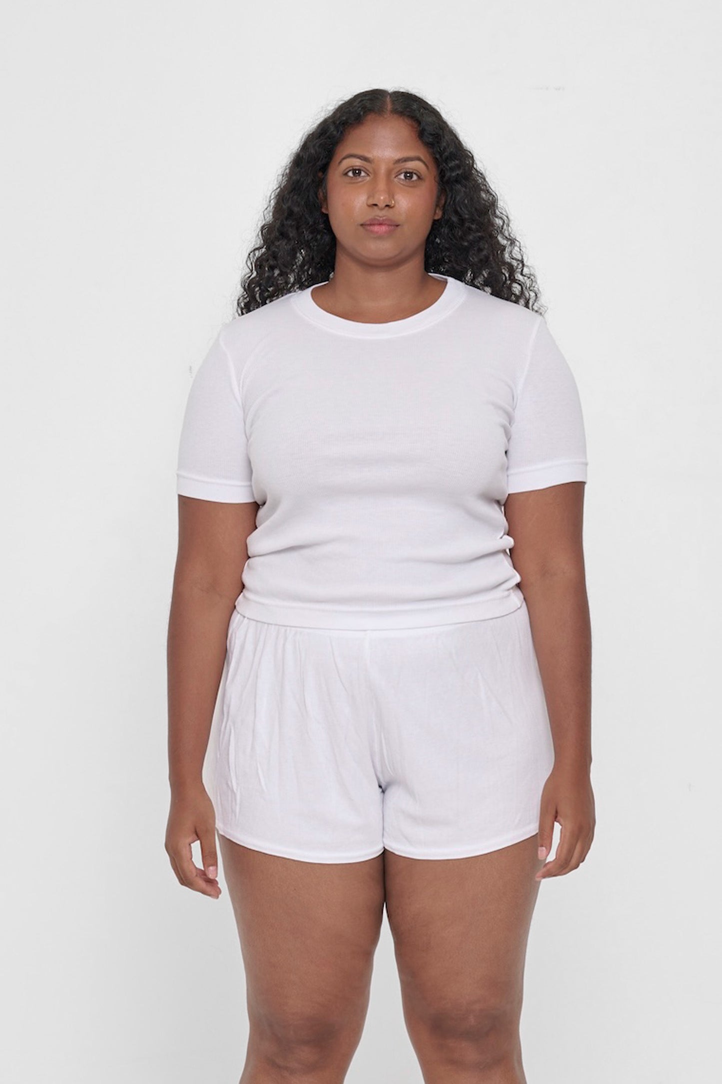 Front view of a 5'8" woman wearing a Rib Short Sleeve in White. Hem rests on her upper hips.