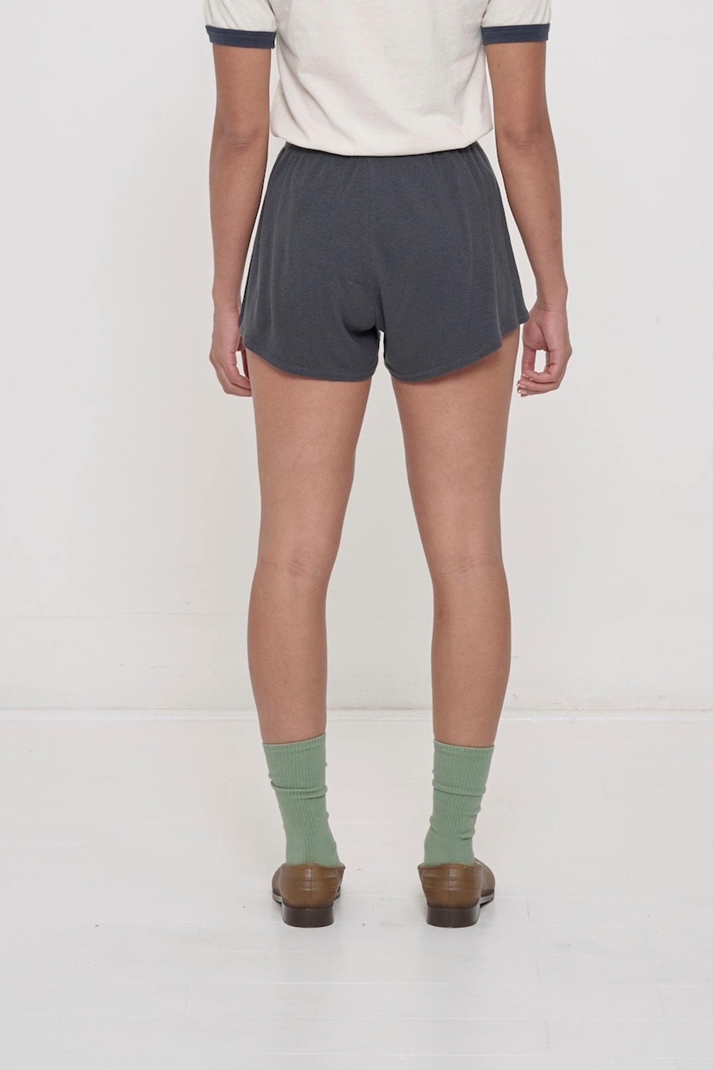 The model is wearing Slate Rib Shorts, shown from the back. They feature a relaxed fit and a flowing, drapey fabric.