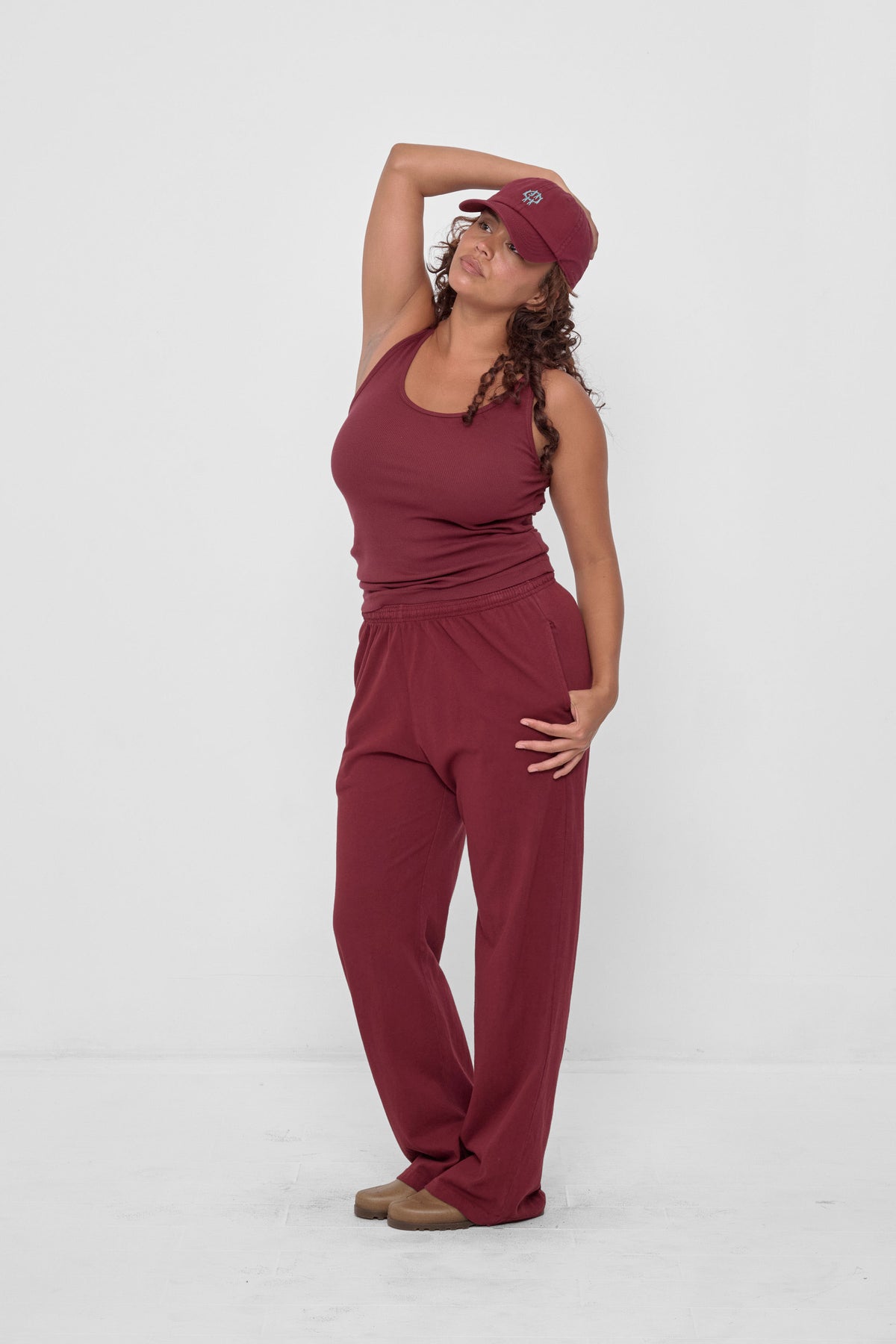 Rib Tank in Garnet - full body view on model, styled with matching Bucky Logo Cap and Apartment Pants