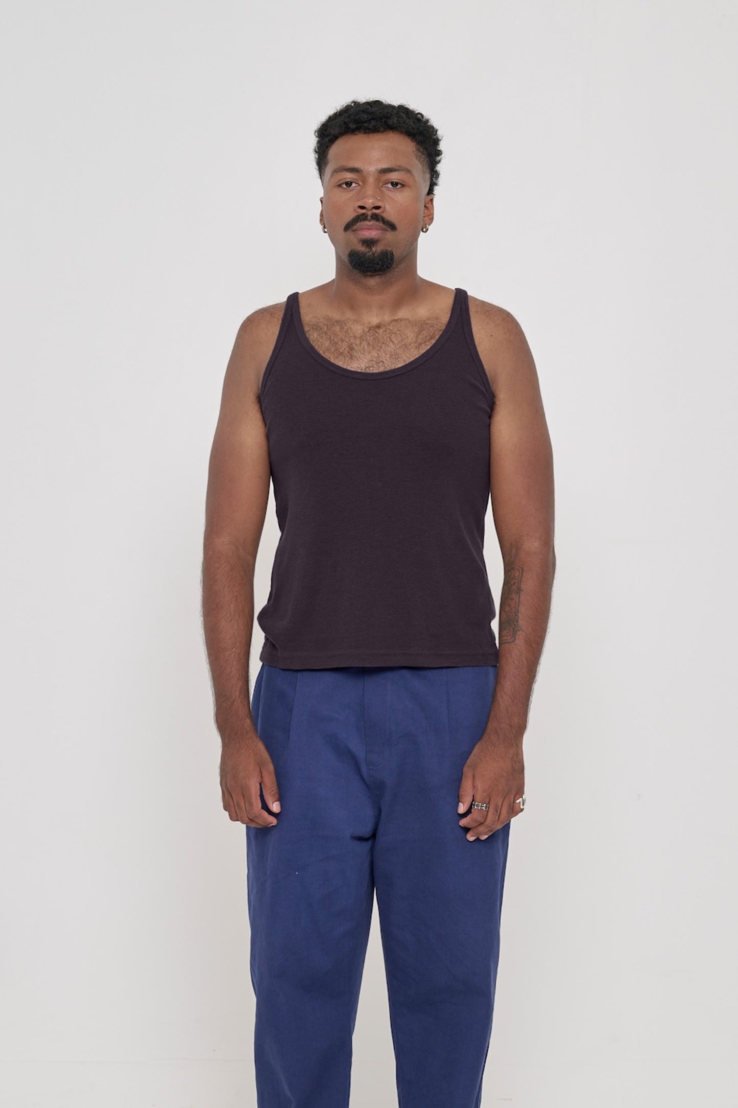 Front view of a 6'2" man wearing a Rib Tank in Mulberry. Hem rests on his upper hips.